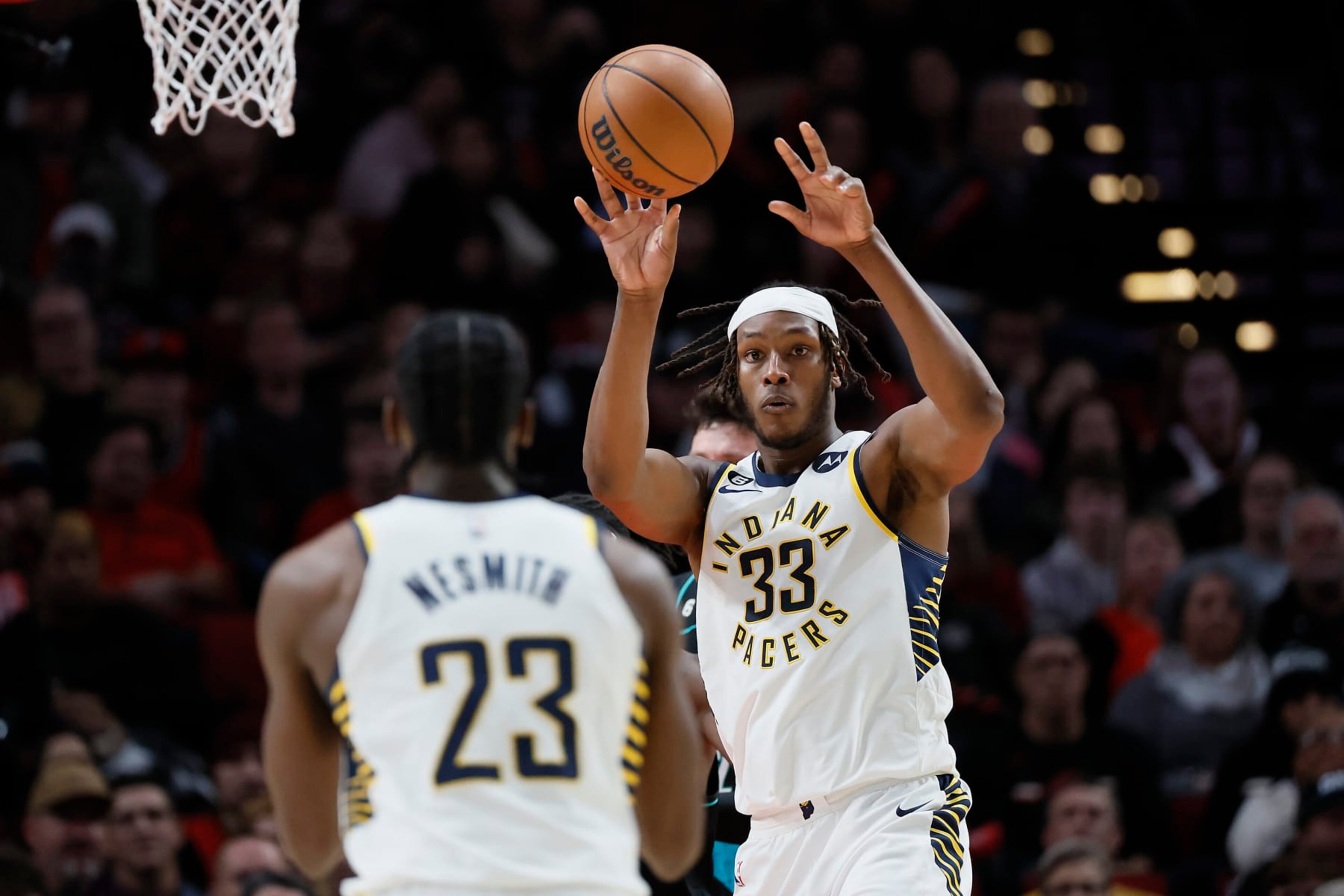 PORTLAND, OREGON - DECEMBER 04: Myles Turner #33 passes the ball to Aaron Nesmith #23 of the Indiana Pacers during the first half against the Portland Trail Blazers at Moda Center on December 04, 2022 in Portland, Oregon. NOTE TO USER: User expressly acknowledges and agrees that, by downloading and or using this photograph, User is consenting to the terms and conditions of the Getty Images License Agreement. (Photo by Soobum Im/Getty Images) PORTLAND, OREGON - DECEMBER 04: Myles Turner #33 passes the ball to Aaron Nesmith #23 of the Indiana Pacers during the first half against the Portland Trail Blazers at Moda Center on December 04, 2022 in Portland, Oregon. NOTE TO USER: User expressly acknowledges and agrees that, by downloading and or using this photograph, User is consenting to the terms and conditions of the Getty Images License Agreement. (Photo by Soobum Im/Getty Images)