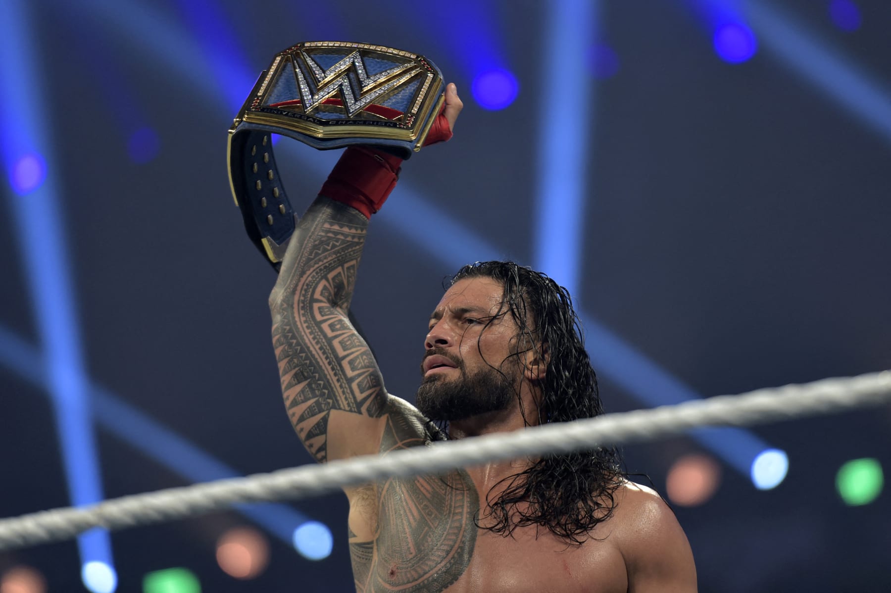 Roman Reigns celebrates after defeating Bill Goldberg during the 2022 WWE Elimination Chamber at the Jeddah Super Dome in Saudi Arabia's Red Sea coastal city of Jeddah on February 19, 2022. (Photo by Amer HILABI / AFP) (Photo by AMER HILABI/AFP via Getty Images)