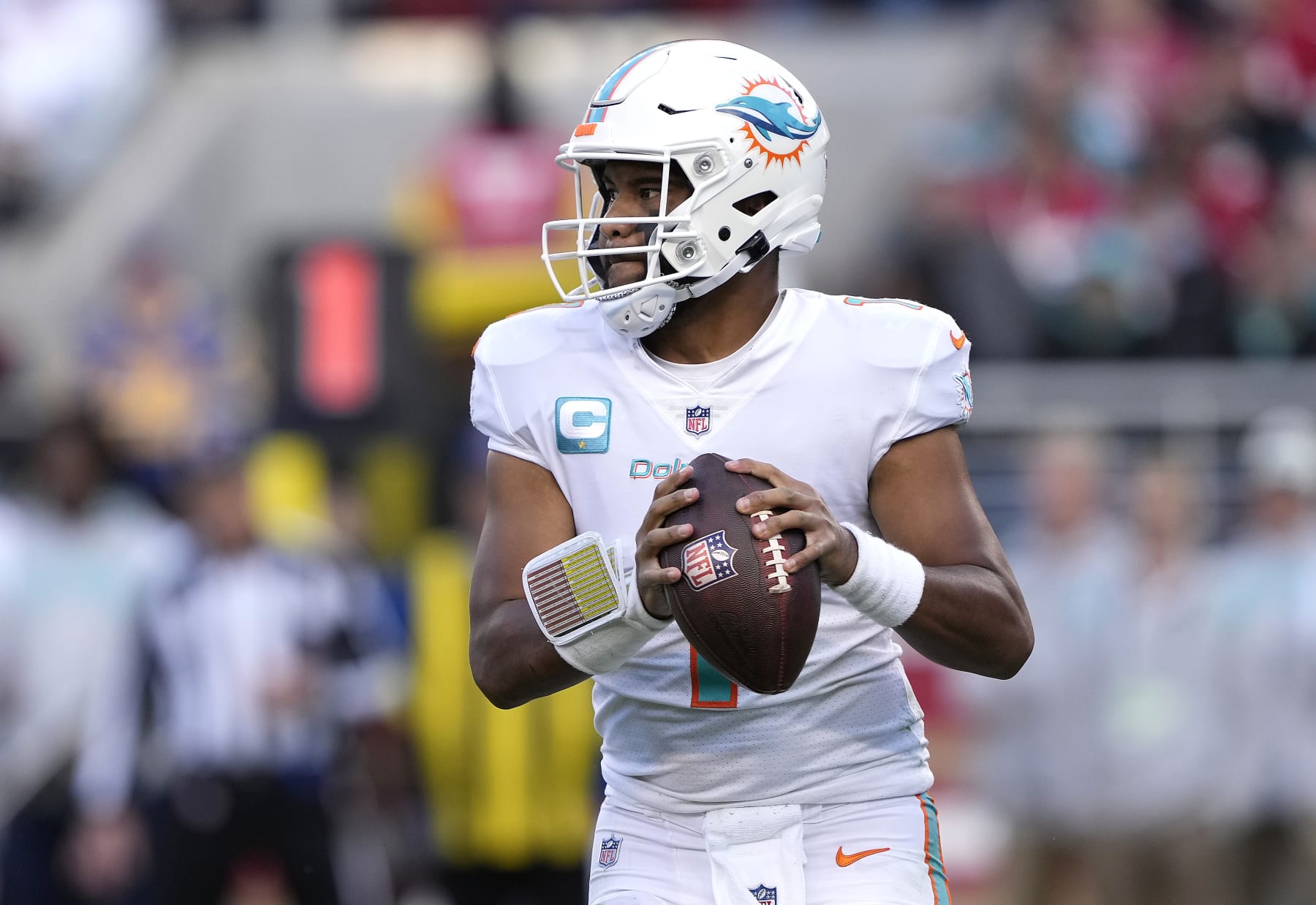 SANTA CLARA, CALIFORNIA - DECEMBER 04: Tua Tagovailoa #1 of the Miami Dolphins rolls out to throw a pass against the San Francisco 49ers during the third quarter of an NFL football game at Levi's Stadium on December 04, 2022 in Santa Clara, California. (Photo by Thearon W. Henderson/Getty Images)