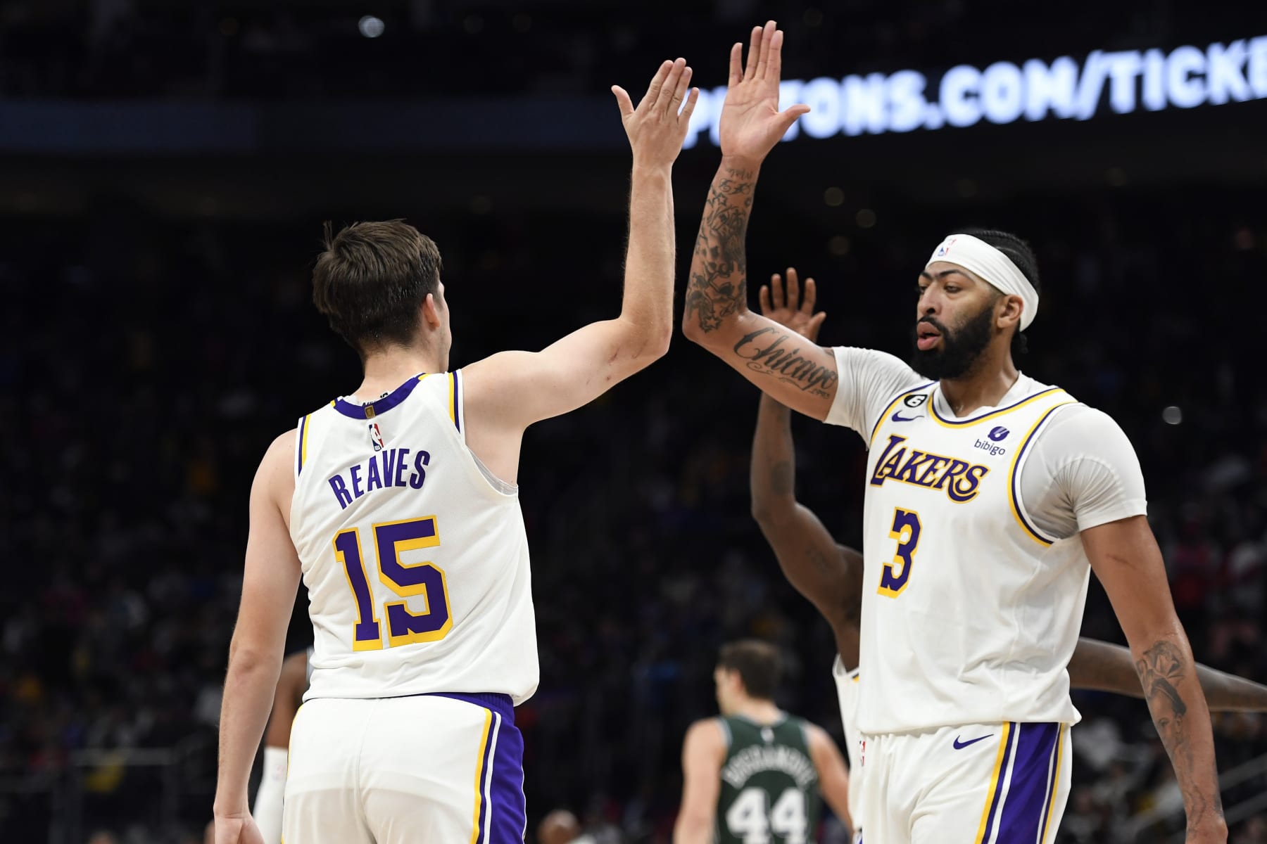 Los Angeles Lakers guard Austin Reaves, left, is congratulated by center Anthony Davis after making a three-point shot near the end of the fourth quarter of an NBA basketball game against the Detroit Pistons, Sunday, Dec. 11, 2022, in Detroit. The Lakers defeated the Pistons 124-117. (AP Photo/Jose Juarez)