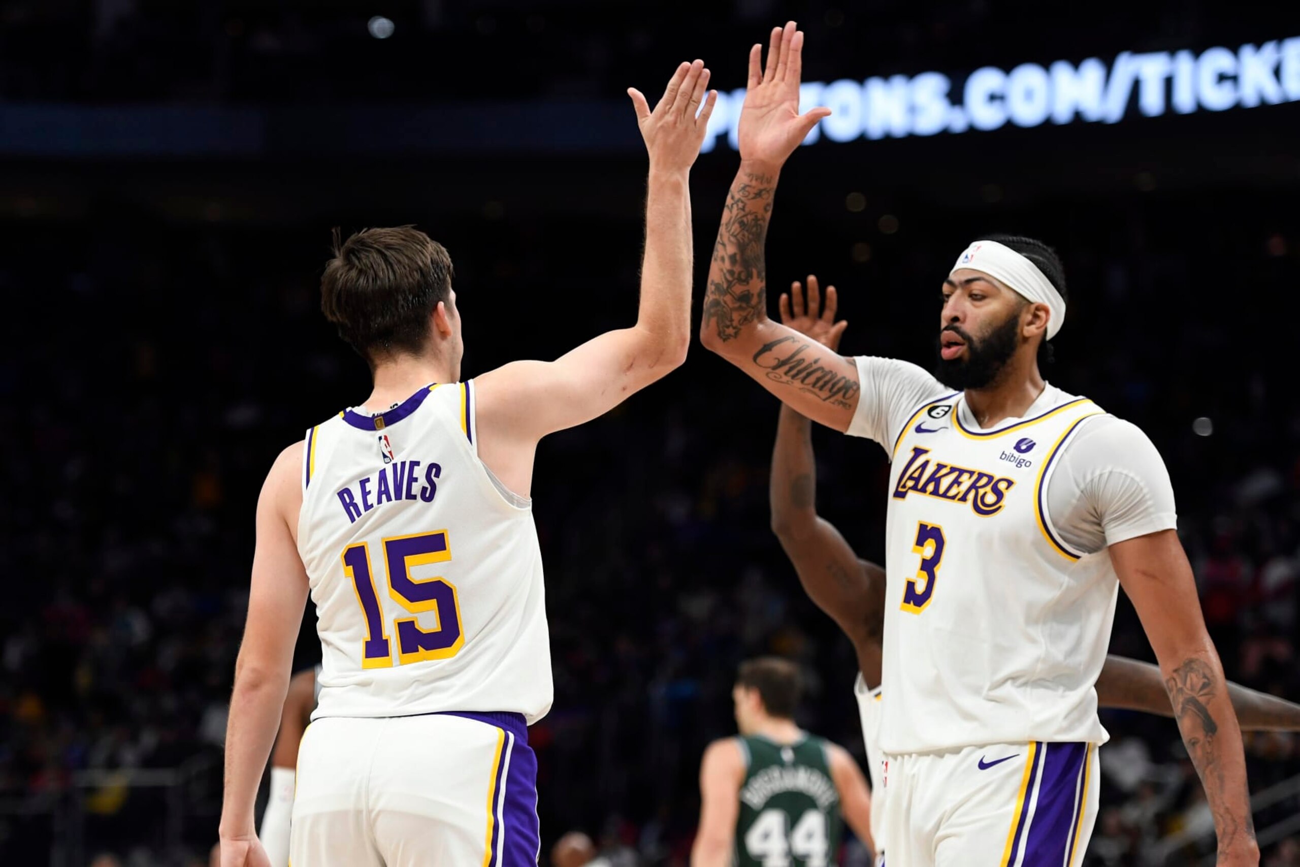 Los Angeles Lakers guard Austin Reaves, left, is congratulated by center Anthony Davis after making a three-point shot near the end of the fourth quarter of an NBA basketball game against the Detroit Pistons, Sunday, Dec. 11, 2022, in Detroit. The Lakers defeated the Pistons 124-117. (AP Photo/Jose Juarez)