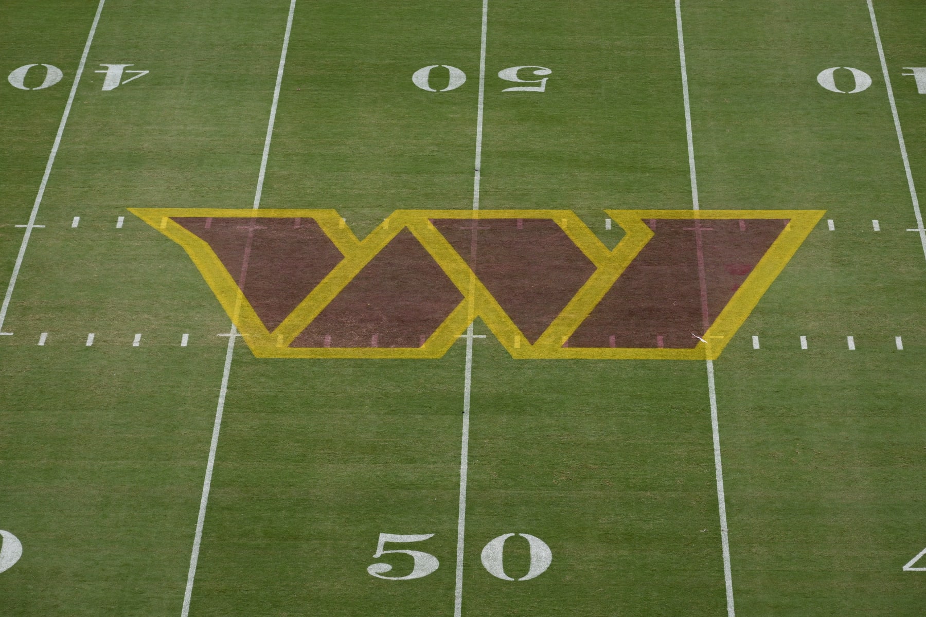 The Washington Commanders logo is seen on the field before a NFL football game between the Washington Commanders and the Jacksonville Jaguars, Sunday, Sept. 11, 2022, in Landover, Md. (AP Photo/Nick Wass)