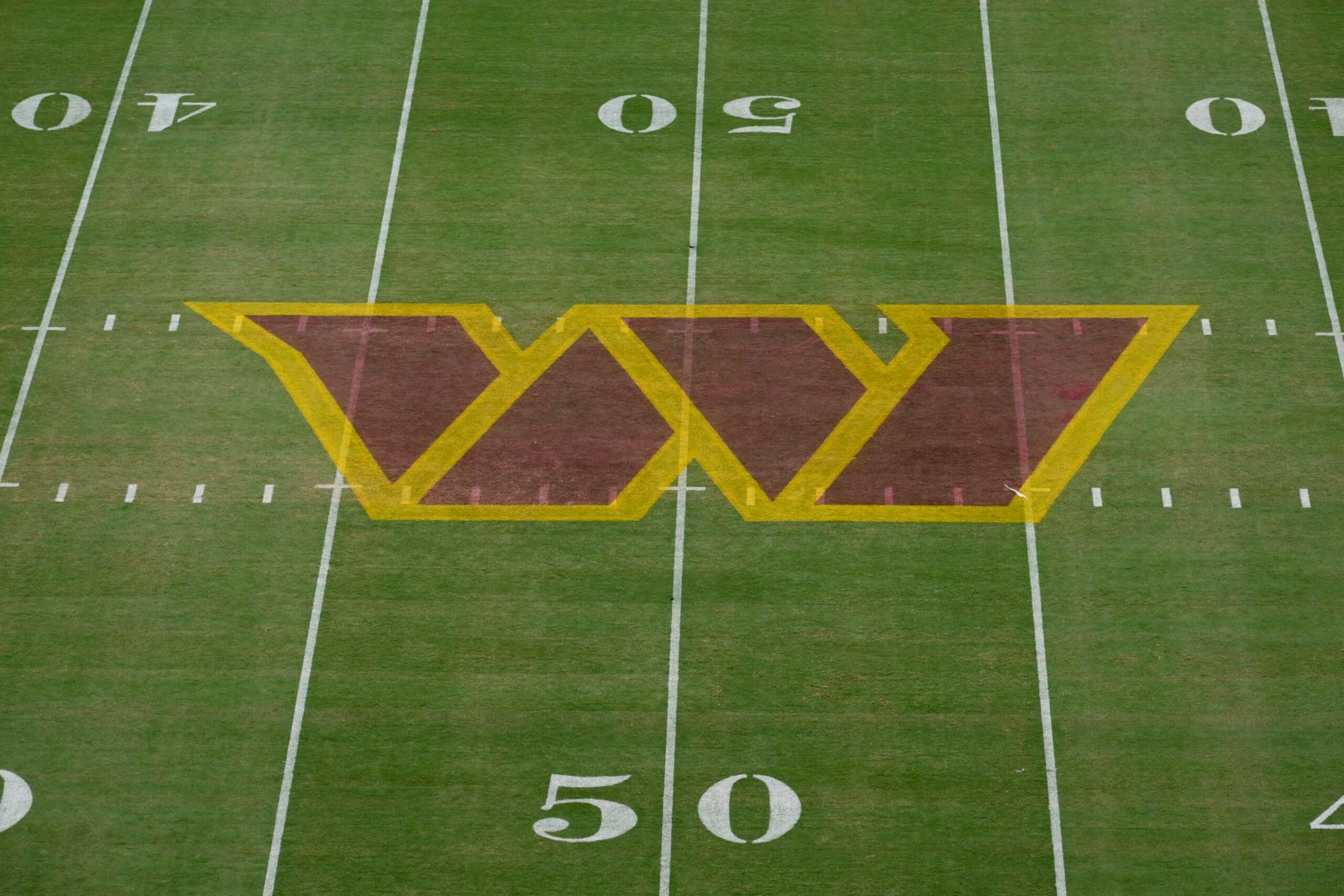 The Washington Commanders logo is seen on the field before a NFL football game between the Washington Commanders and the Jacksonville Jaguars, Sunday, Sept. 11, 2022, in Landover, Md. (AP Photo/Nick Wass)