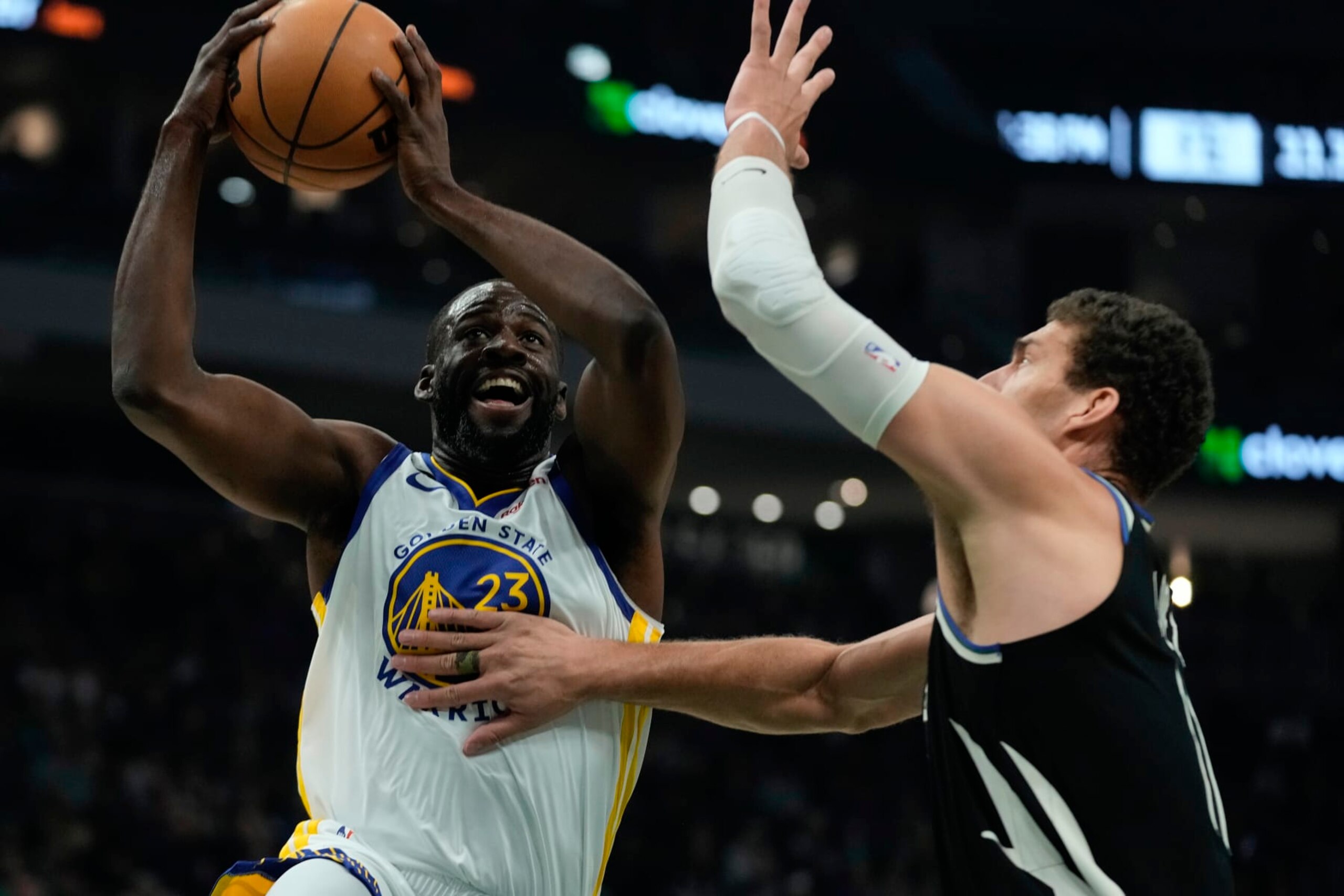 Golden State Warriors' Draymond Green shoots past Milwaukee Bucks' Brook Lopez during the first half of an NBA basketball game Tuesday, Dec. 13, 2022, in Milwaukee. (AP Photo/Morry Gash)