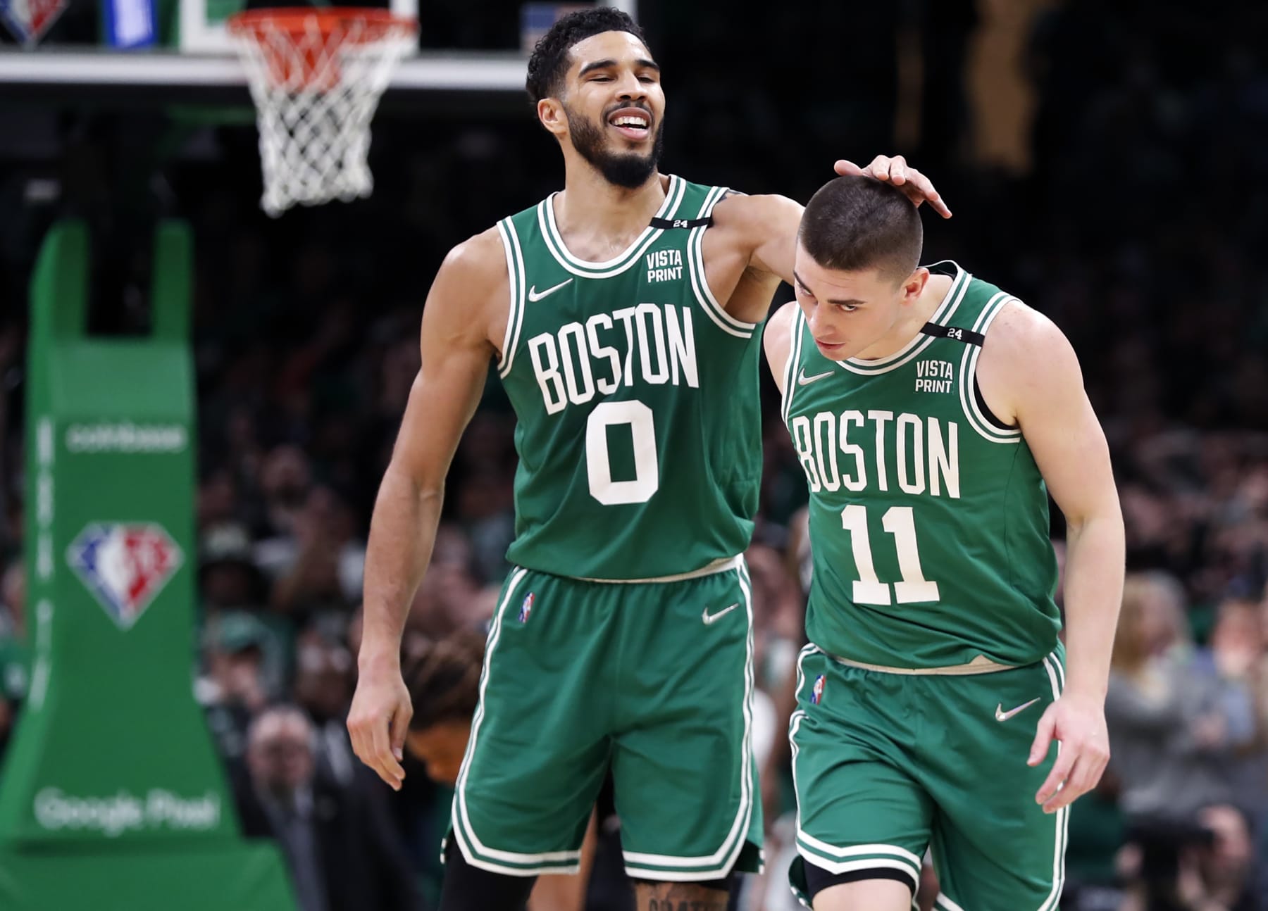 Boston - April 20: After the Celtics Payton Pritchard (right) hit one of his several big shots in the fourth quarter to help seal the Boston win, he gets a head rub from teammate Jayson Tatum (left). The Boston Celtics hosted the Brooklyn Nets for Game Two of their first round NBA Playoff series held at the TD Garden in Boston on April 20, 2022. (Photo by Jim Davis/The Boston Globe via Getty Images)