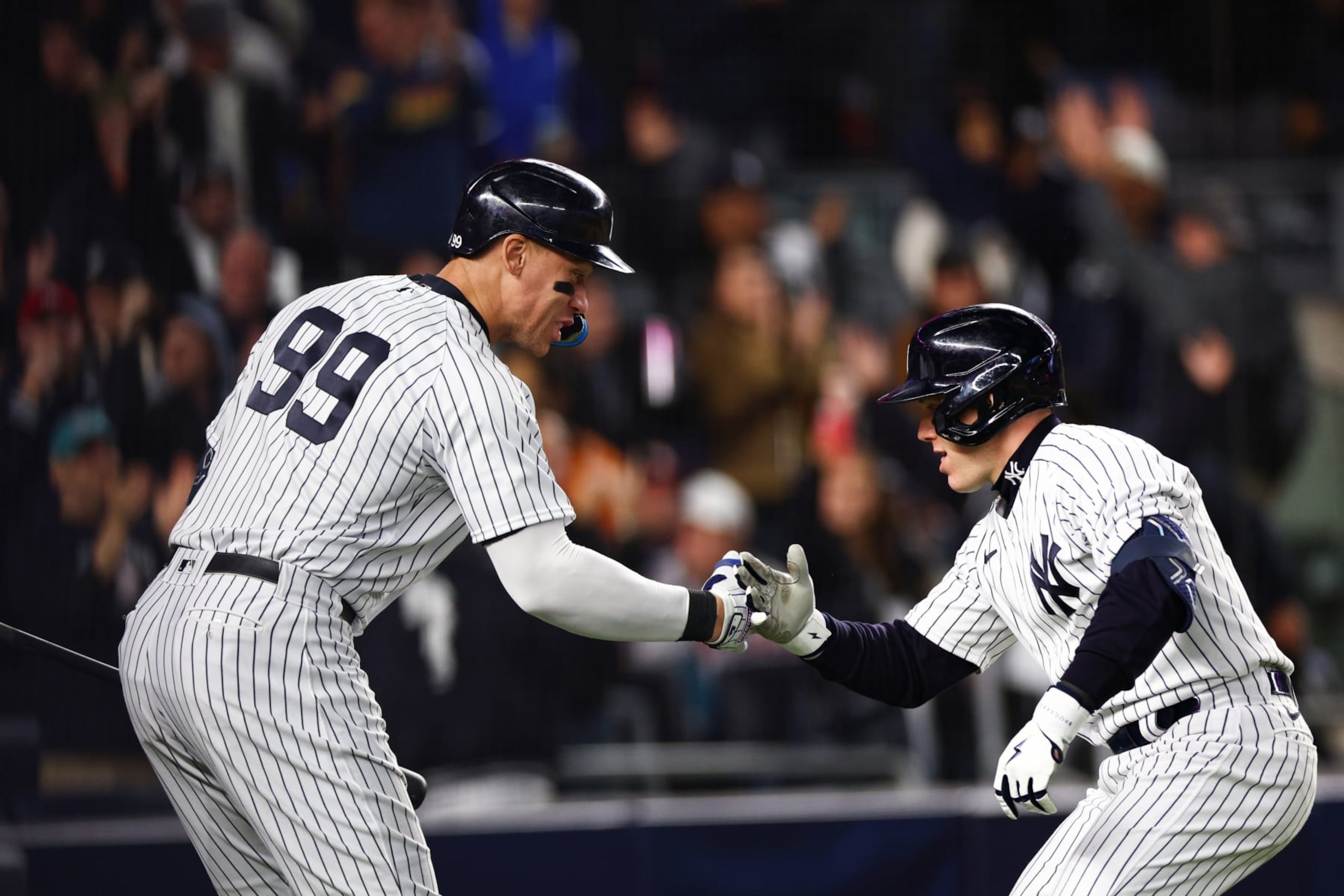 NEW YORK, NEW YORK - OCTOBER 23: Harrison Bader #22 of the New York Yankees celebrates his home run with Aaron Judge #99 during the sixth inning against the Houston Astros in game four of the American League Championship Series at Yankee Stadium on October 23, 2022 in the Bronx borough of New York City. (Photo by Elsa/Getty Images)
