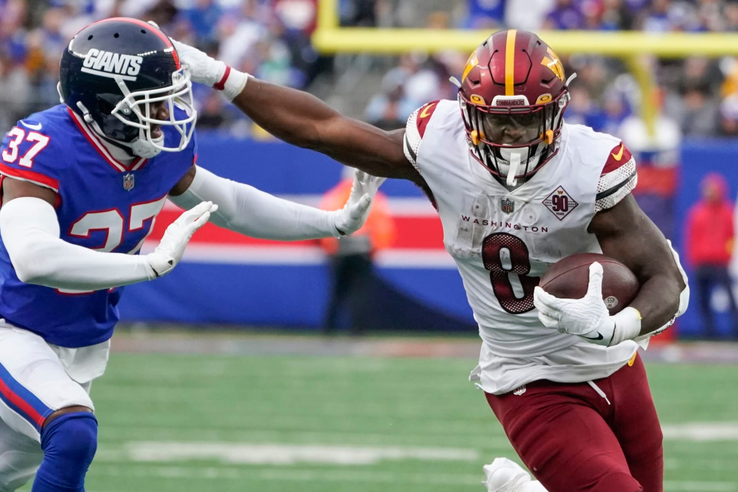Washington Commanders' Brian Robinson Jr., right, runs the ball during the second half of an NFL football game against the New York Giants, Sunday, Dec. 4, 2022, in East Rutherford, N.J. (AP Photo/John Minchillo)