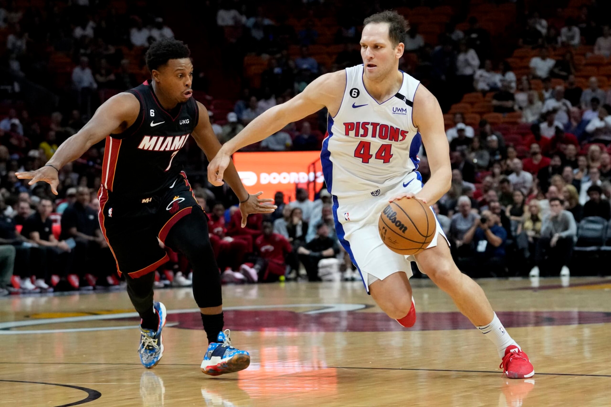 Miami Heat guard Kyle Lowry (7) defends against Detroit Pistons forward Bojan Bogdanovic (44) during the first half of an NBA basketball game Tuesday, Dec. 6, 2022, in Miami. (AP Photo/Lynne Sladky)