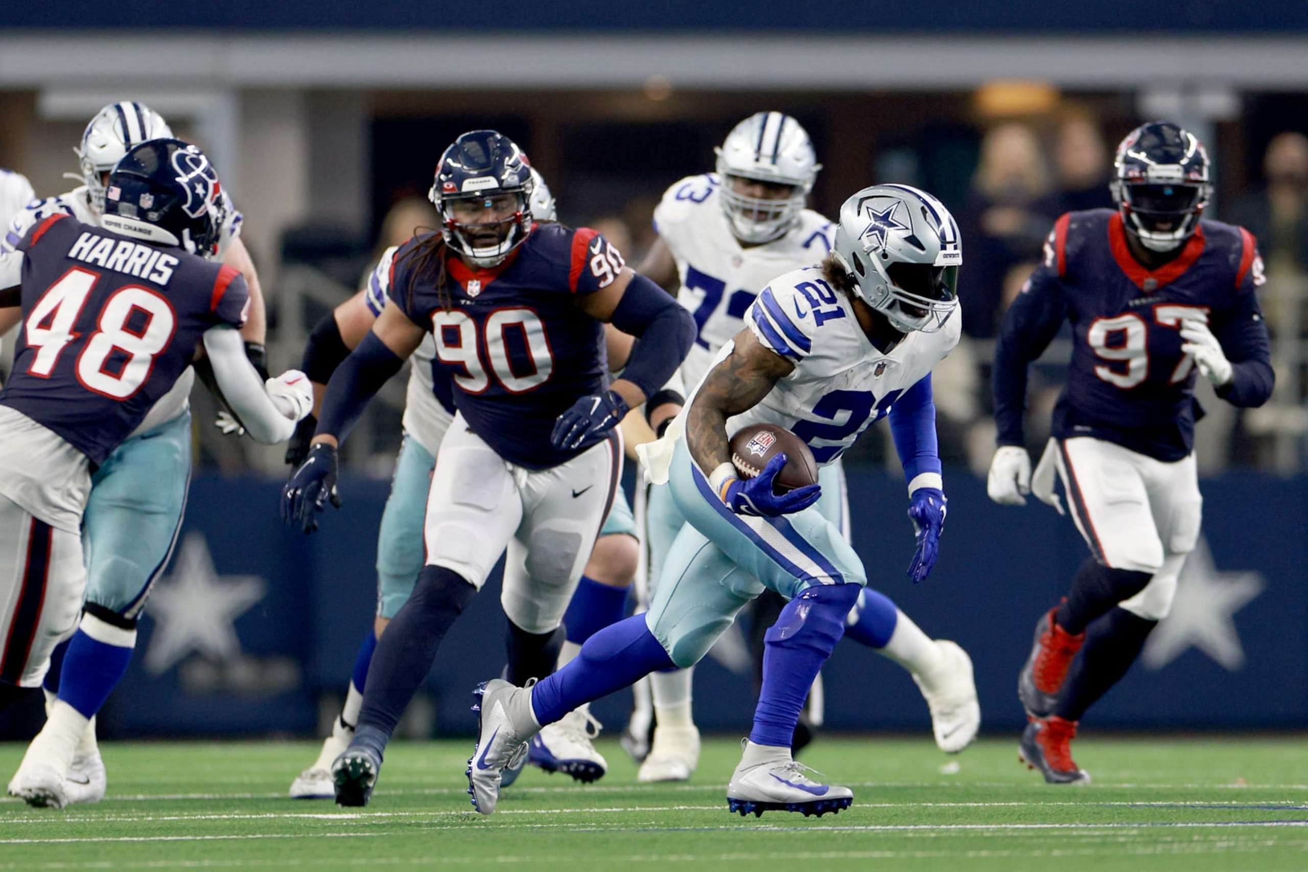 ARLINGTON, TEXAS - DECEMBER 11: Running back Ezekiel Elliott #21 of the Dallas Cowboys carries the ball against linebacker Christian Kirksey #58 of the Houston Texans in the fourth quarter at AT&T Stadium on December 11, 2022 in Arlington, Texas. (Photo by Tom Pennington/Getty Images)