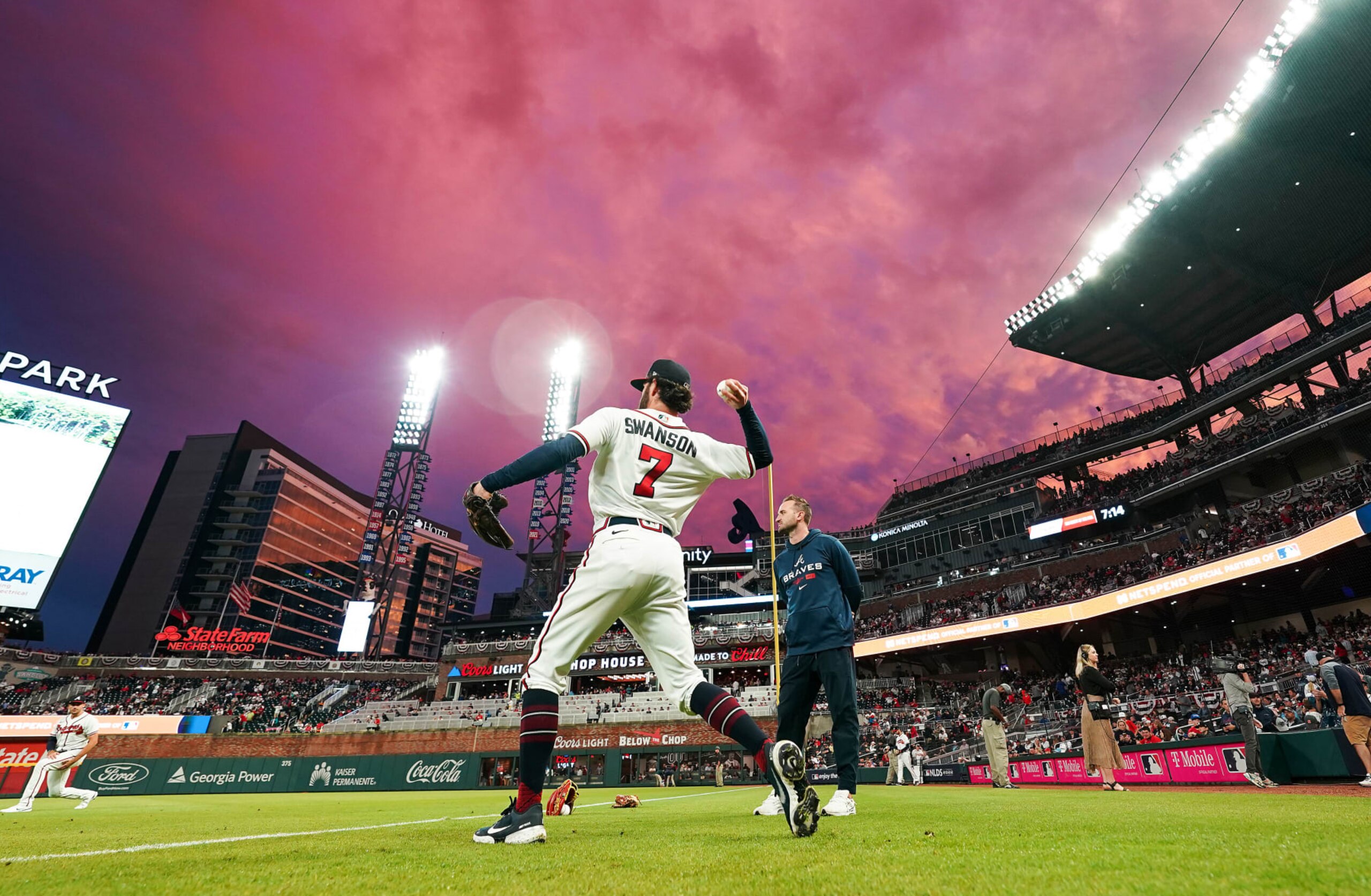 ATLANTA, GA - OCTOBER 12: Dansby Swanson #7 of the Atlanta Braves warms up as the the sun sets before game two of the National League Division Series at Truist Park on October 12, 2022 in Atlanta, Georgia. (Photo by Kevin D. Liles/Atlanta Braves/Getty Images)