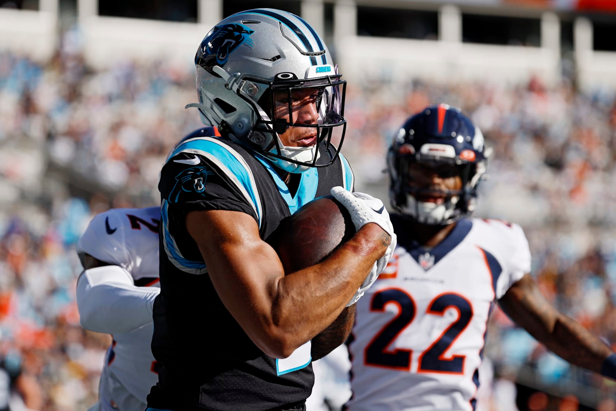 CHARLOTTE, NORTH CAROLINA - NOVEMBER 27: DJ Moore #2 of the Carolina Panthers catches the ball for a touchdown as Pat Surtain II #2 and Kareem Jackson #22 of the Denver Broncos defend during the first quarter at Bank of America Stadium on November 27, 2022 in Charlotte, North Carolina. (Photo by Jared C. Tilton/Getty Images)