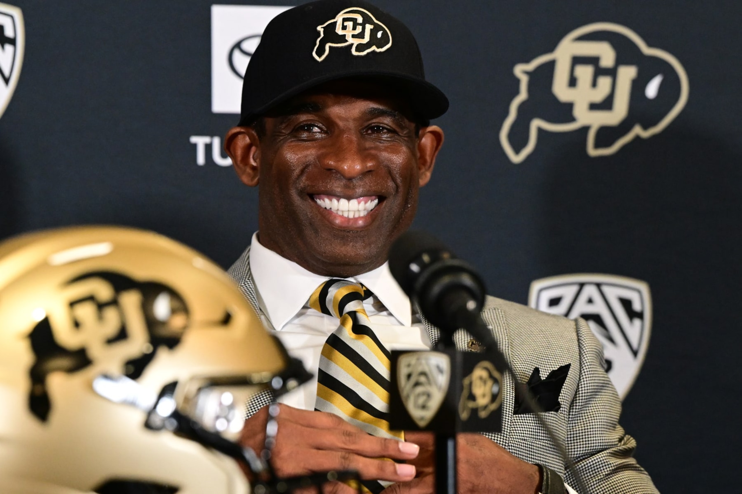 BOULDER, CO - DECEMBER 4:  Deion Sanders, CUs new head football coach, takes questions in the Arrow Touchdown Club during a press conference on December 4, 2022 in Boulder, Colorado. CU held an introductory press conference to announce the hiring of Deion Coach Prime Sanders as the schools new head football coach. Chancellor Phil DiStefano and athletic director Rick George accompanied Sanders into a packed room in the Arrow Touchdown Club inside the Dal Ward Athletic Center. Sanders becomes the 28th head coach in Buffalo football history.  Sanders, who known as Prime Time during his Hall of Fame playing career has since transitioned into Coach Prime as a head football coach. Sanders, 55, joins the CU program from Jackson State University where in three seasons the Tigers compiled a 27-5 record and won back-to-back Southwestern Athletic Conference championships. (Photo by Helen H. Richardson/MediaNews Group/The Denver Post via Getty Images)