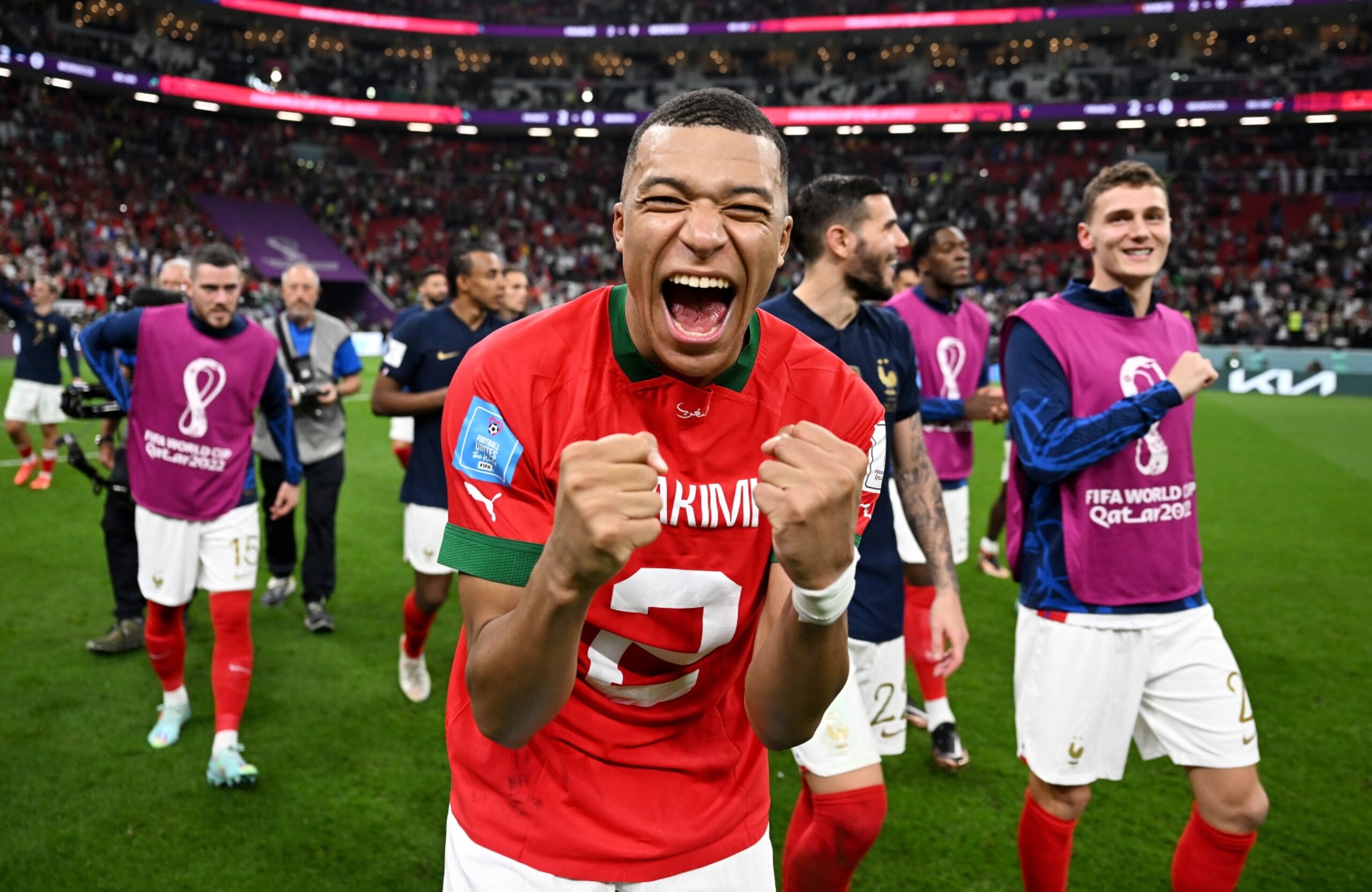 AL KHOR, QATAR - DECEMBER 14: Kylian Mbappe of France celebrates the 2-0 win after exchanging shirts with Achraf Hakimi of Morocco (not pictured) during the FIFA World Cup Qatar 2022 semi final match between France and Morocco at Al Bayt Stadium on December 14, 2022 in Al Khor, Qatar. (Photo by Michael Regan - FIFA/FIFA via Getty Images)