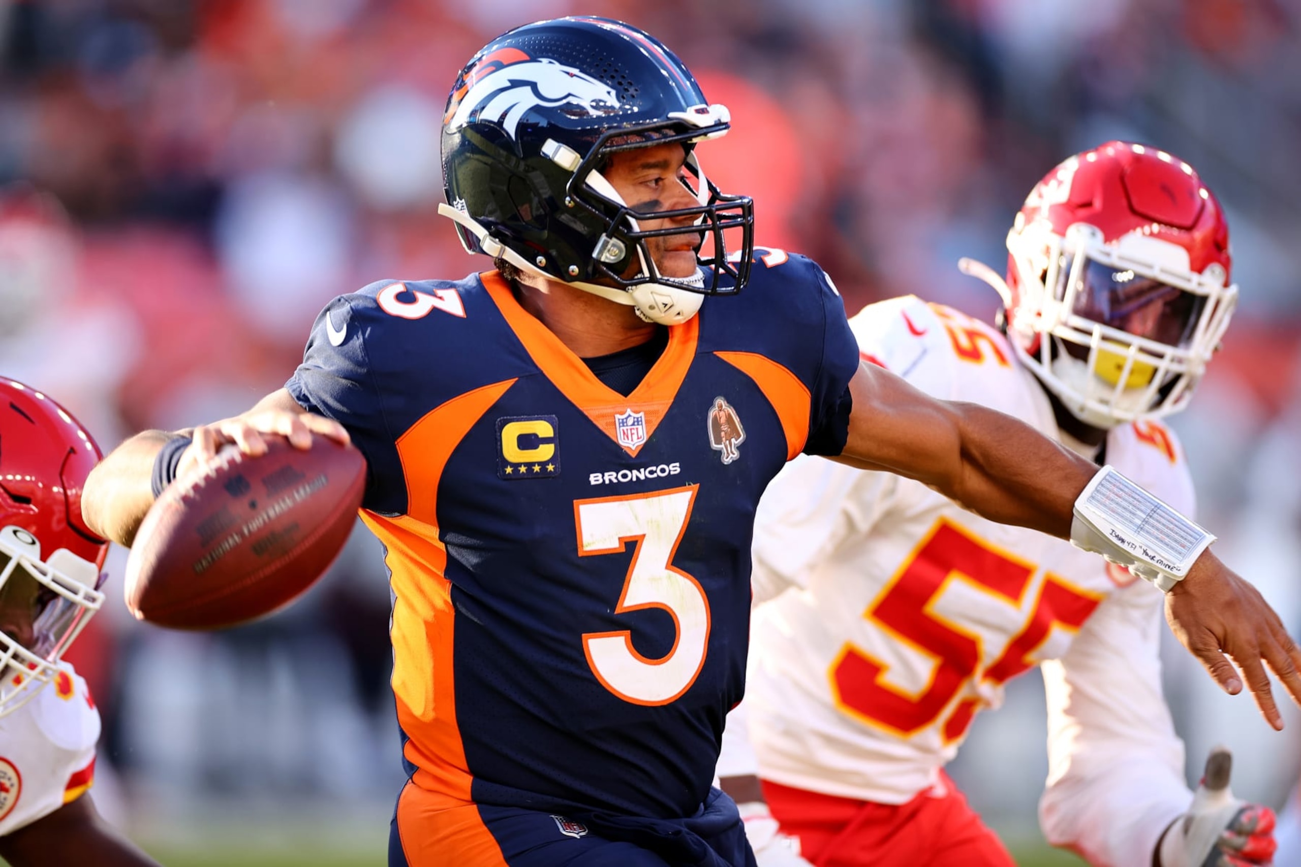 DENVER, COLORADO - DECEMBER 11: Russell Wilson #3 of the Denver Broncos avoids the rush against the Kansas City Chiefs at Empower Field At Mile High on December 11, 2022 in Denver, Colorado. (Photo by Jamie Schwaberow/Getty Images)