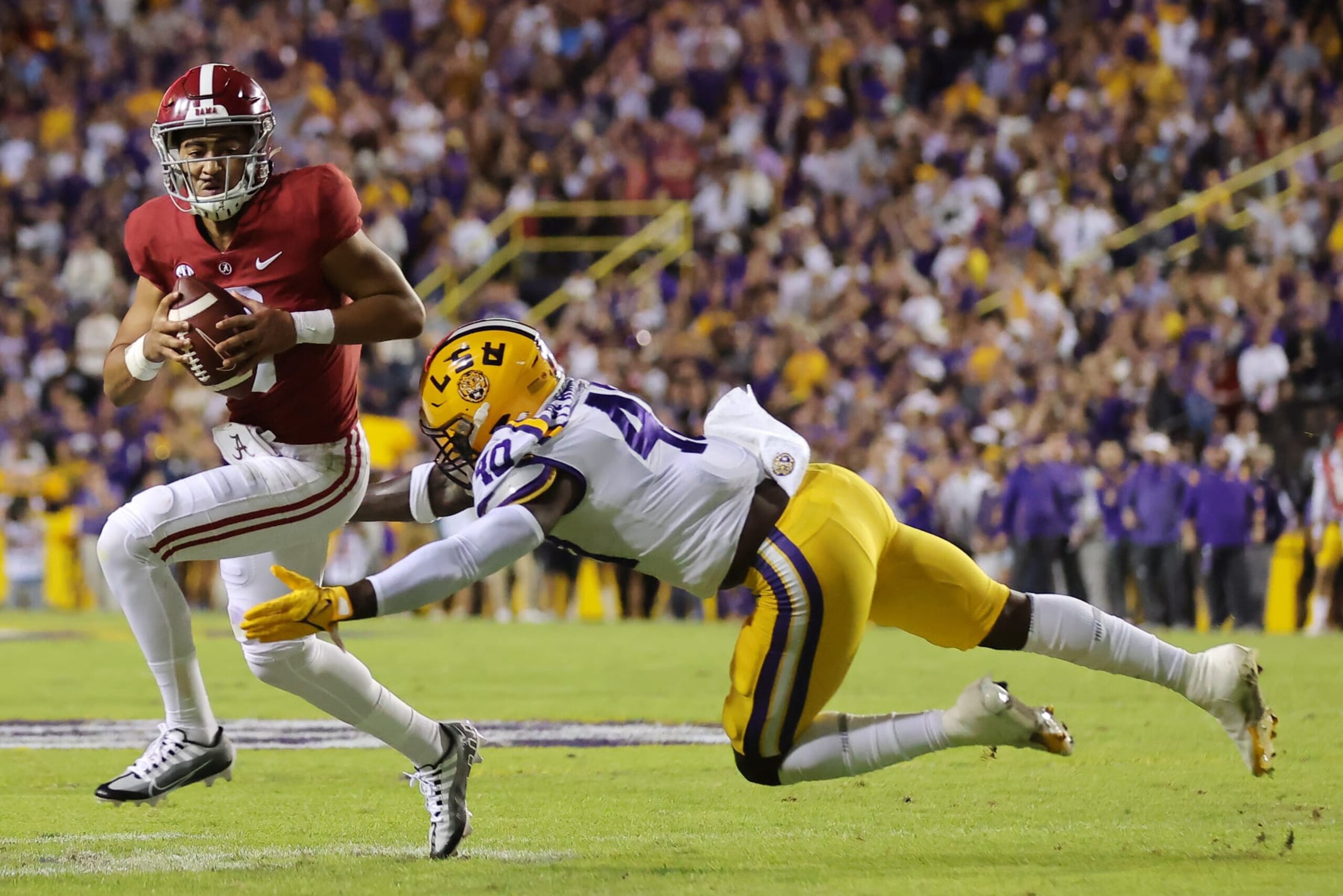 BATON ROUGE, LOUISIANA - NOVEMBER 05: Bryce Young #9 of the Alabama Crimson Tide is tackled by Harold Perkins Jr. #40 of the LSU Tigers during the first half at Tiger Stadium on November 05, 2022 in Baton Rouge, Louisiana. (Photo by Jonathan Bachman/Getty Images) BATON ROUGE, LOUISIANA - NOVEMBER 05: Bryce Young #9 of the Alabama Crimson Tide is tackled by Harold Perkins Jr. #40 of the LSU Tigers during the first half at Tiger Stadium on November 05, 2022 in Baton Rouge, Louisiana. (Photo by Jonathan Bachman/Getty Images)