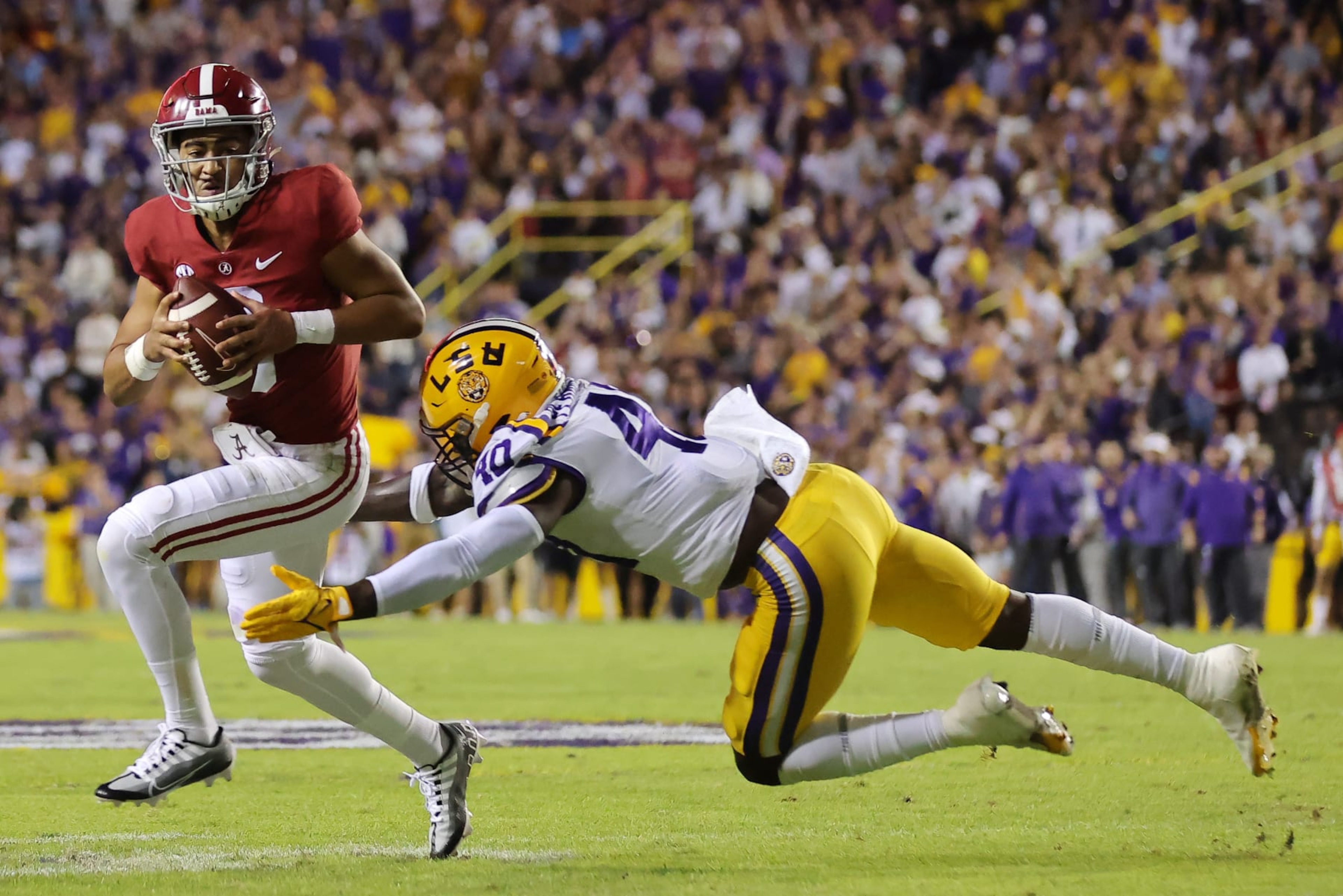 BATON ROUGE, LOUISIANA - NOVEMBER 05: Bryce Young #9 of the Alabama Crimson Tide is tackled by Harold Perkins Jr. #40 of the LSU Tigers during the first half at Tiger Stadium on November 05, 2022 in Baton Rouge, Louisiana. (Photo by Jonathan Bachman/Getty Images)