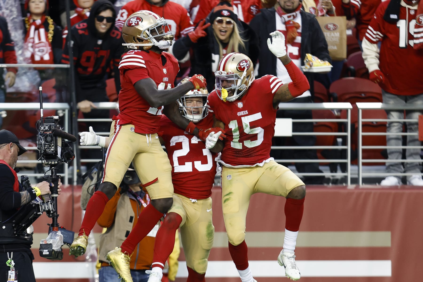San Francisco 49ers running back Christian McCaffrey (23) celebrates with wide receivers Brandon Aiyuk, left, and Jauan Jennings, right, after scoring a touchdown during the second half of an NFL football game against the Tampa Bay Buccaneers in Santa Clara, Calif., Sunday, Dec. 11, 2022. (AP Photo/Jed Jacobsohn)