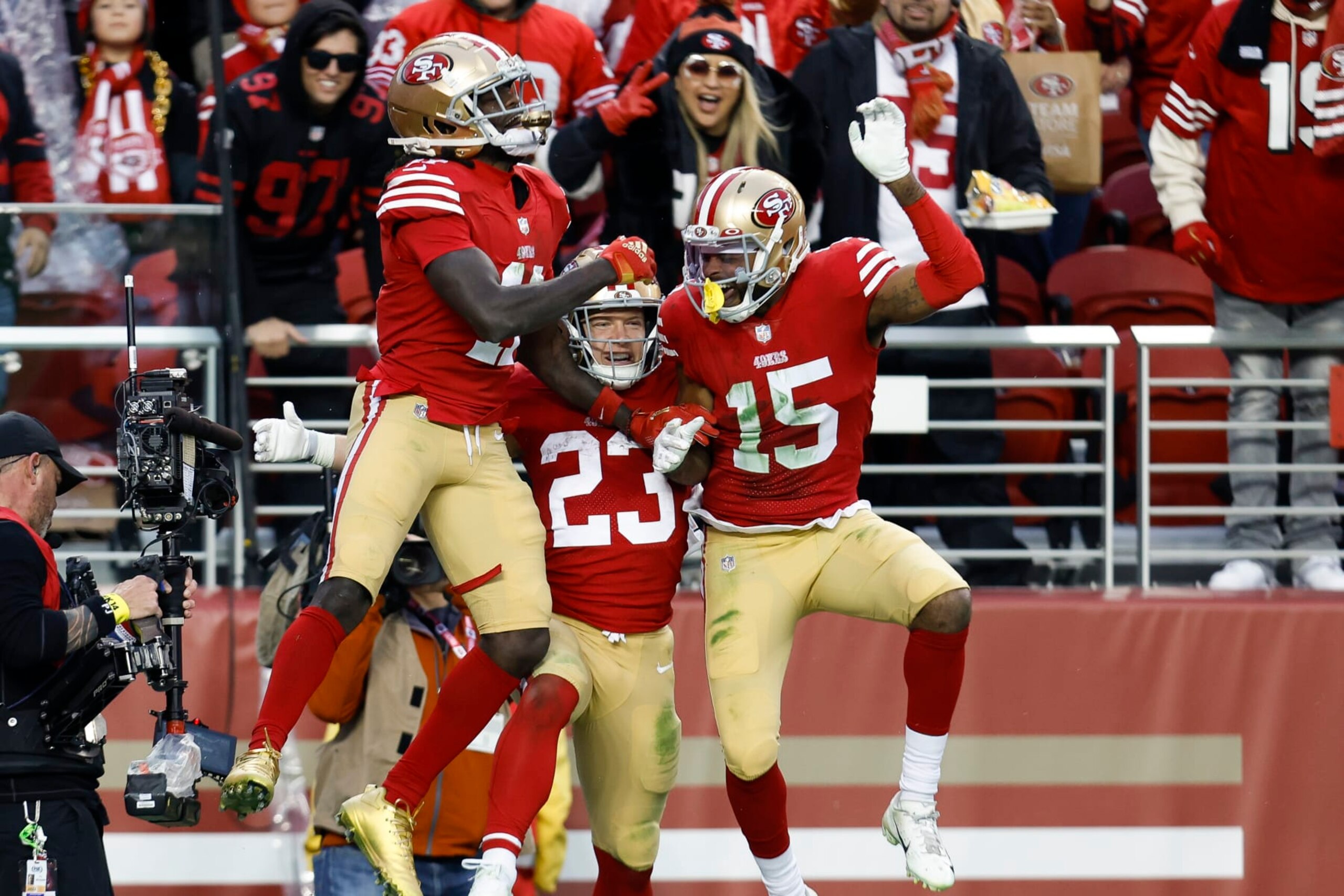San Francisco 49ers running back Christian McCaffrey (23) celebrates with wide receivers Brandon Aiyuk, left, and Jauan Jennings, right, after scoring a touchdown during the second half of an NFL football game against the Tampa Bay Buccaneers in Santa Clara, Calif., Sunday, Dec. 11, 2022. (AP Photo/Jed Jacobsohn)