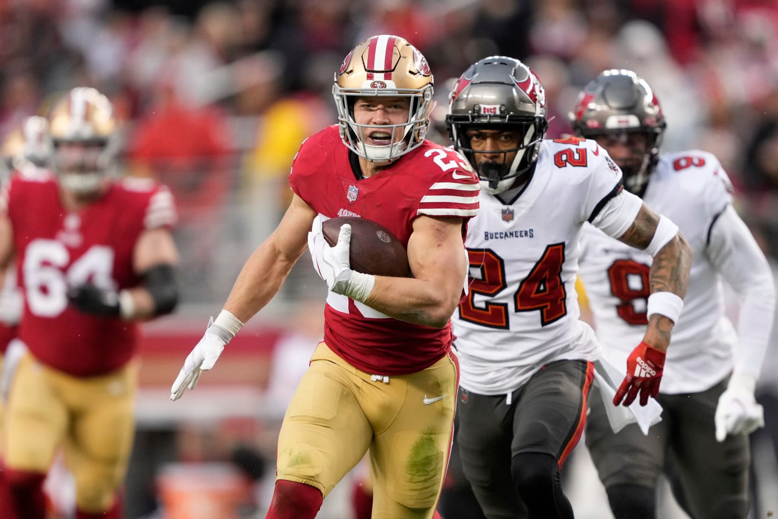 San Francisco 49ers running back Christian McCaffrey (23) runs for a touchdown against Tampa Bay Buccaneers cornerback Carlton Davis III (24) during the second half of an NFL football game in Santa Clara, Calif., Sunday, Dec. 11, 2022. (AP Photo/Tony Avelar)