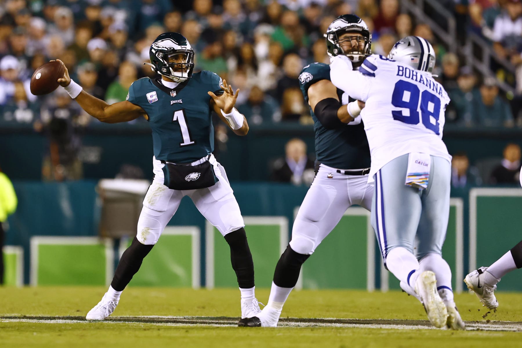 Philadelphia Eagles quarterback Jalen Hurts (1) attempts a pass as his center Jason Kelce (62) protects him from Dallas Cowboys defensive tackle Quinton Bohanna (98) during an NFL football game, Sunday, Oct. 16, 2022, in Philadelphia. (AP Photo/Rich Schultz)