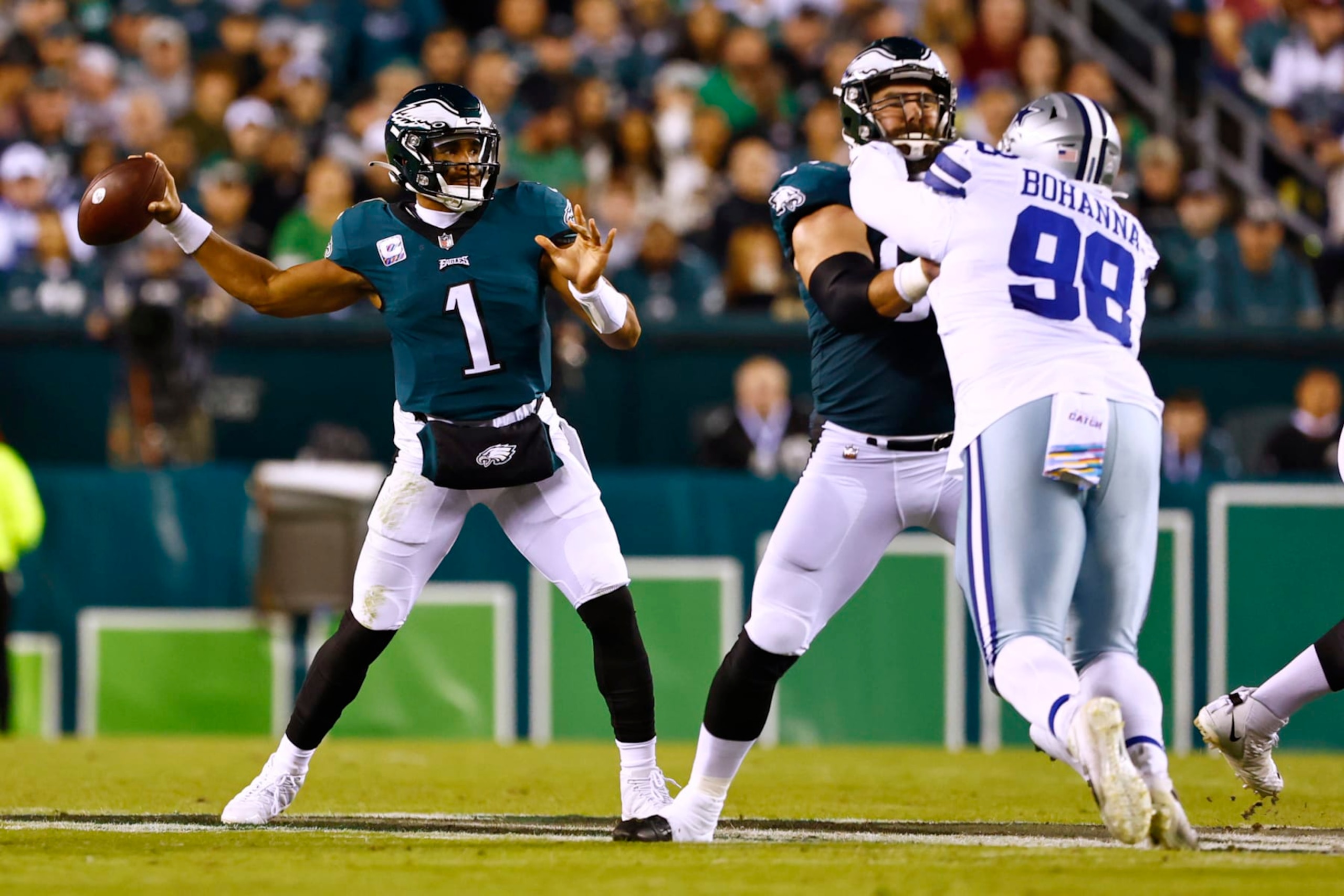 Philadelphia Eagles quarterback Jalen Hurts (1) attempts a pass as his center Jason Kelce (62) protects him from Dallas Cowboys defensive tackle Quinton Bohanna (98) during an NFL football game, Sunday, Oct. 16, 2022, in Philadelphia. (AP Photo/Rich Schultz)