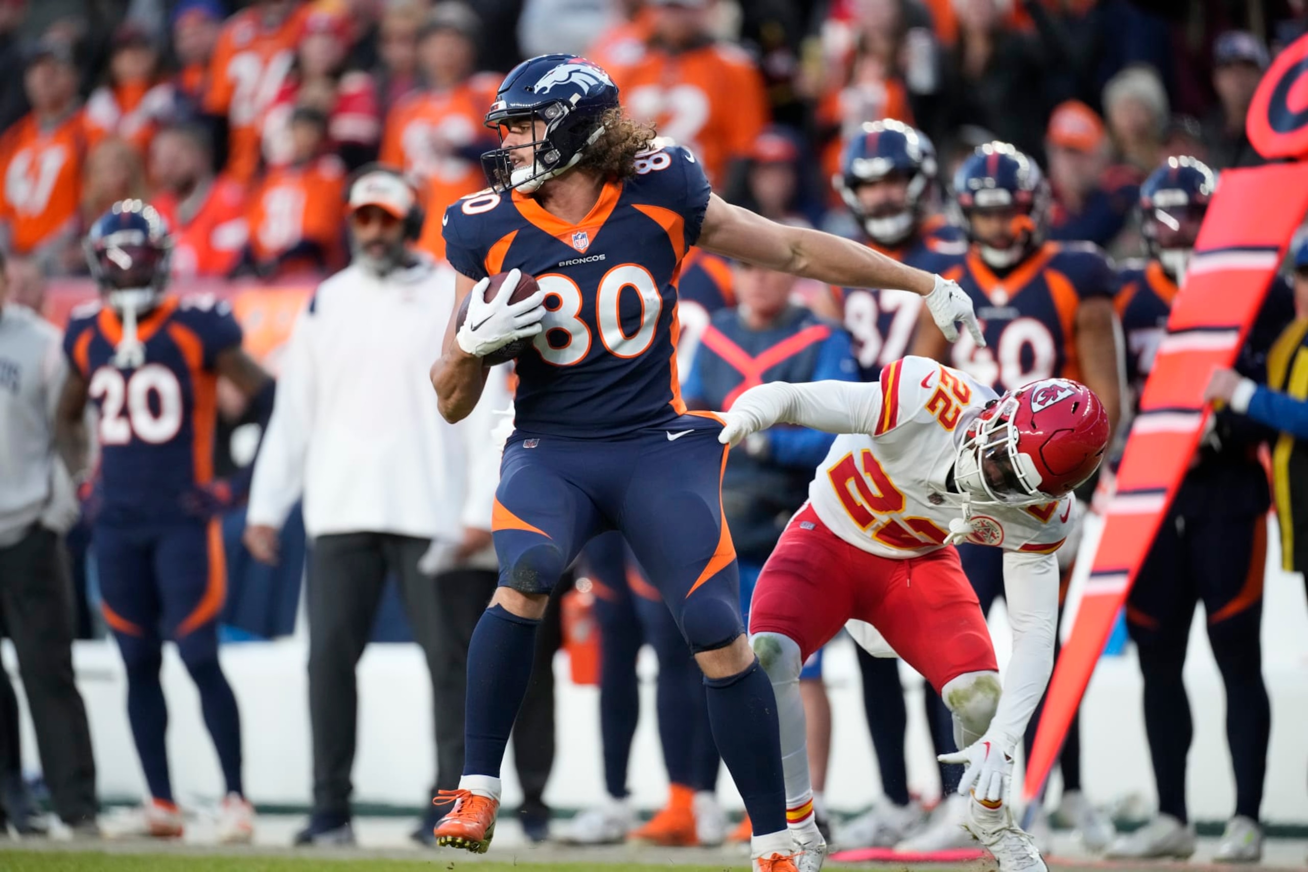 Denver Broncos tight end Greg Dulcich (80) and Kansas City Chiefs safety Juan Thornhill (22) in the second half of an NFL football game Sunday, Dec. 11, 2022, in Denver. (AP Photo/David Zalubowski)