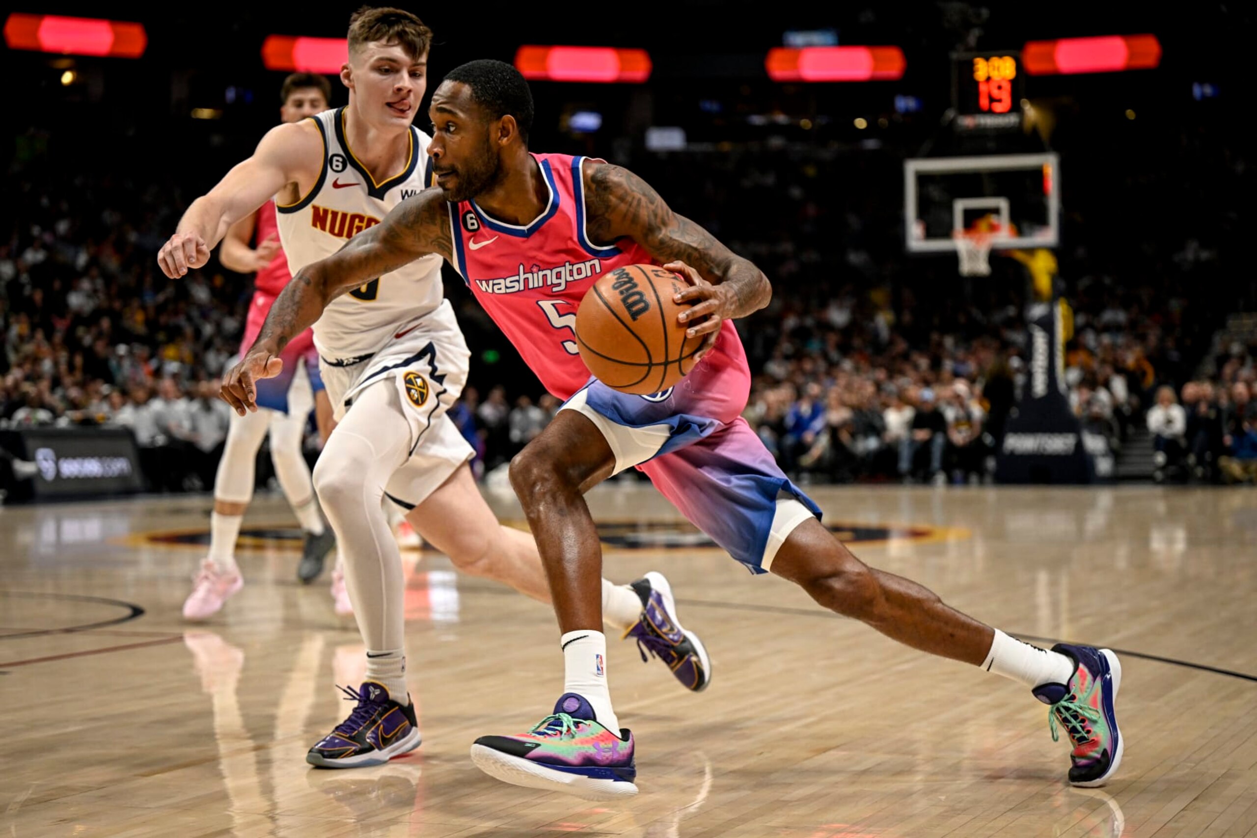 DENVER, CO - DECEMBER 14: Will Barton (5) of the Washington Wizards drives on Christian Braun (0) of the Denver Nuggets during the first quarter at Ball Arena in Denver on Wednesday, December 14, 2022. (Photo by AAron Ontiveroz/MediaNews Group/The Denver Post via Getty Images)