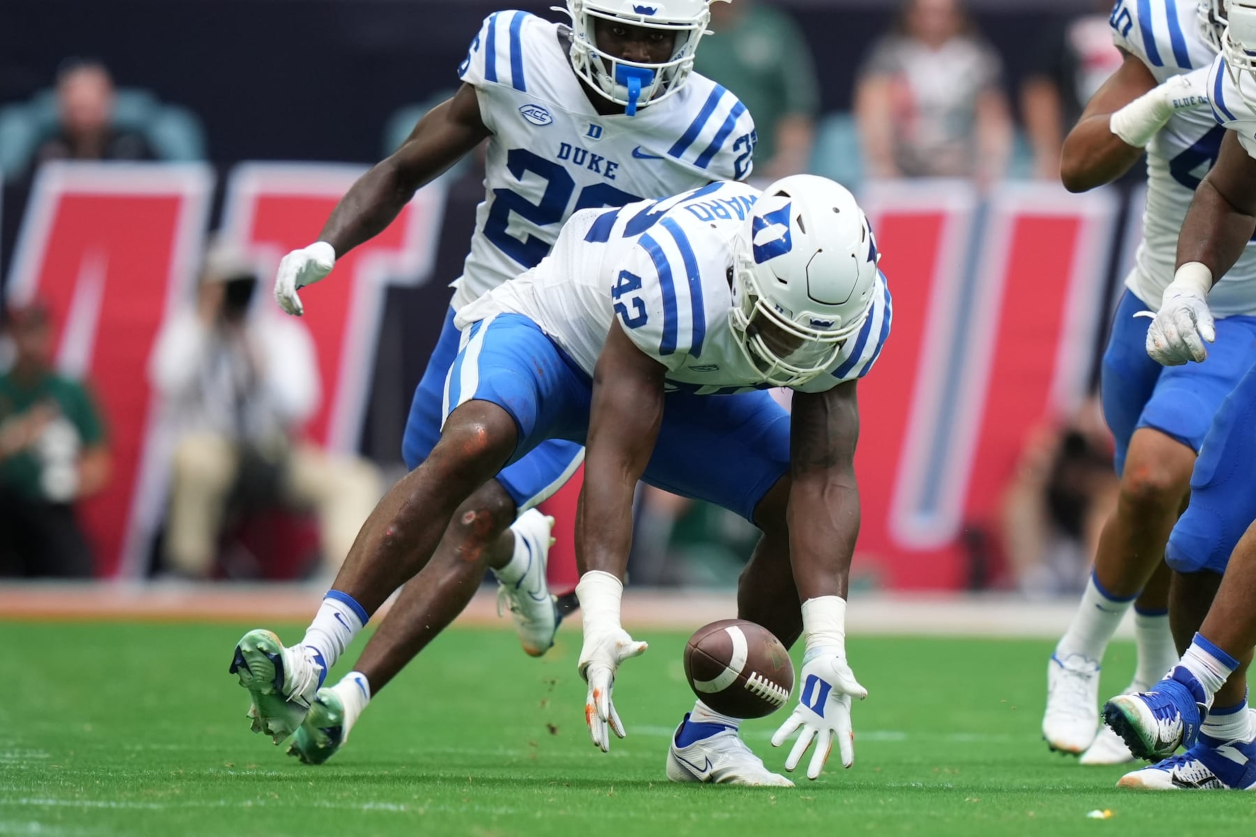 MIAMI GARDENS, FL - OCTOBER 22: Duke Blue Devils linebacker Shaka Heyward (42) picks up a fumble during the game between the Duke Blue Devils and the Miami Hurricanes on Saturday, October 22, 2022 at Hard Rock Stadium, Miami Gardens, FL (Photo by Peter Joneleit/Icon Sportswire via Getty Images)