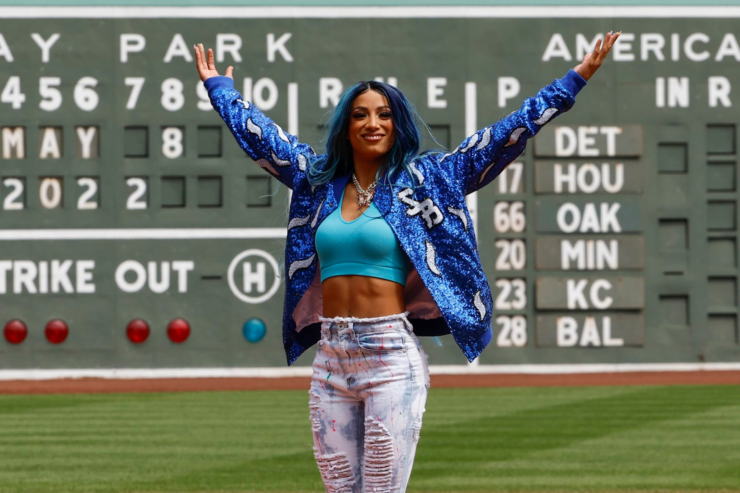 BOSTON, MA - MAY 8: Six time WWE Women's Champion Sasha Banks holds up her arms after throwing out the first pitch before the game between the Boston Red Sox and the Chicago White Sox at Fenway Park on May 8, 2022 in Boston, Massachusetts. (Photo By Winslow Townson/Getty Images)
