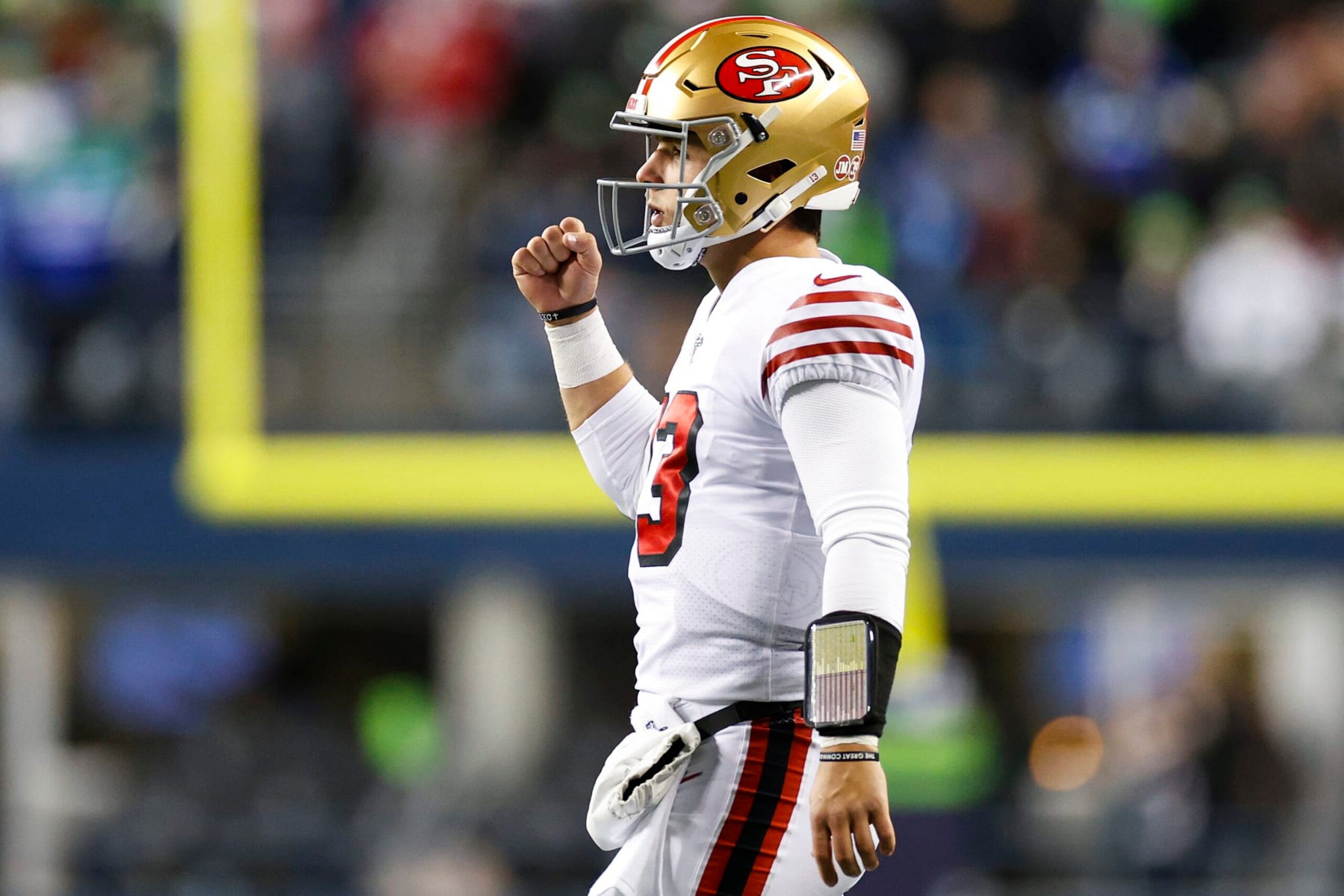 SEATTLE, WASHINGTON - DECEMBER 15: Brock Purdy #13 of the San Francisco 49ers celebrates after a touchdown against the Seattle Seahawks during the third quarter of the game at Lumen Field on December 15, 2022 in Seattle, Washington. (Photo by Steph Chambers/Getty Images)