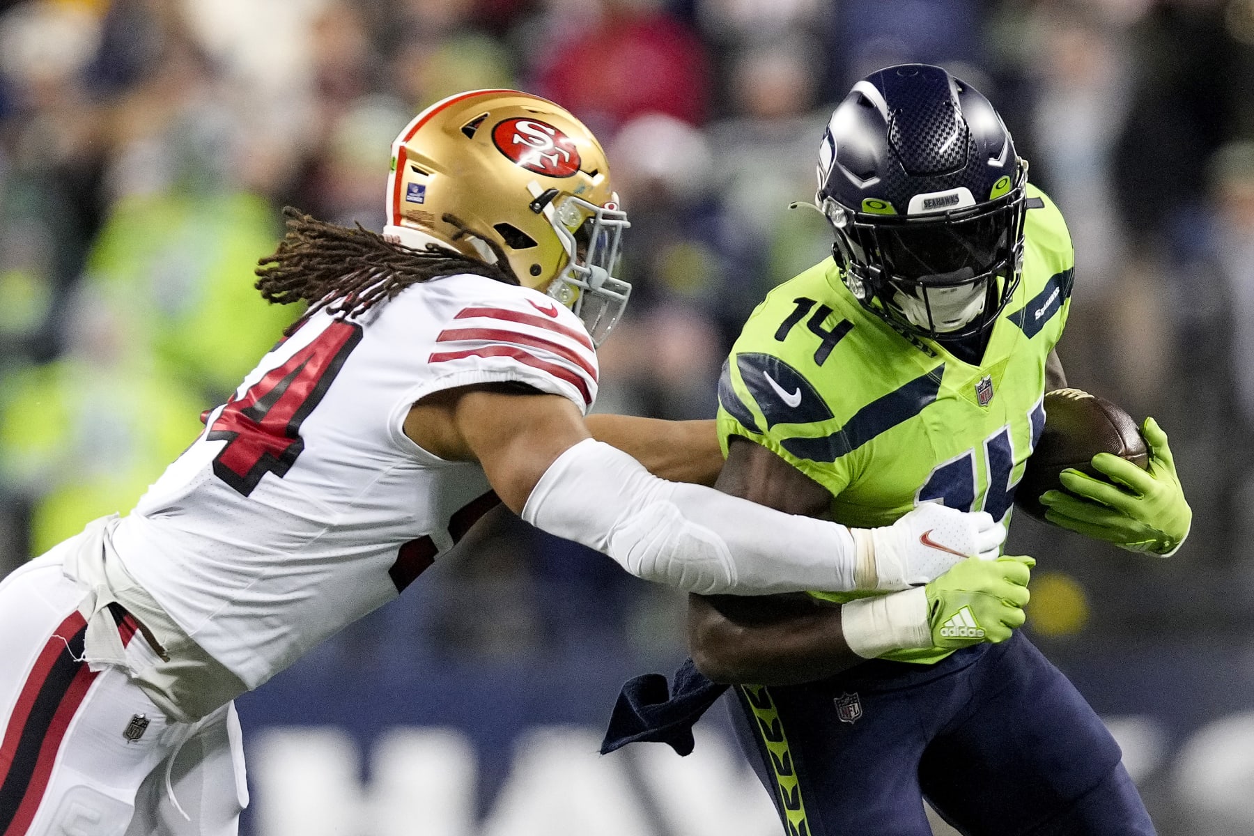 SEATTLE, WASHINGTON - DECEMBER 15: DK Metcalf #14 of the Seattle Seahawks carries the ball against Fred Warner #54 of the San Francisco 49ers \d3q at Lumen Field on December 15, 2022 in Seattle, Washington. (Photo by Christopher Mast/Getty Images)