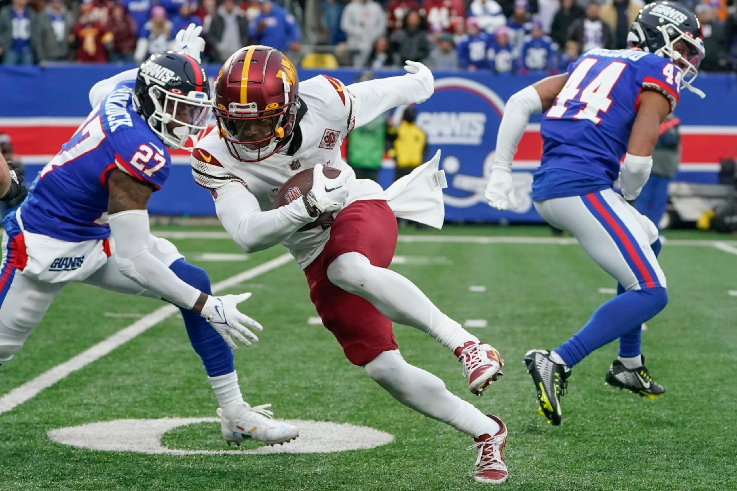 Washington Commanders' Jahan Dotson, center, runs for a touchdown during the second half of an NFL football game against the New York Giants, Sunday, Dec. 4, 2022, in East Rutherford, N.J. (AP Photo/John Minchillo)