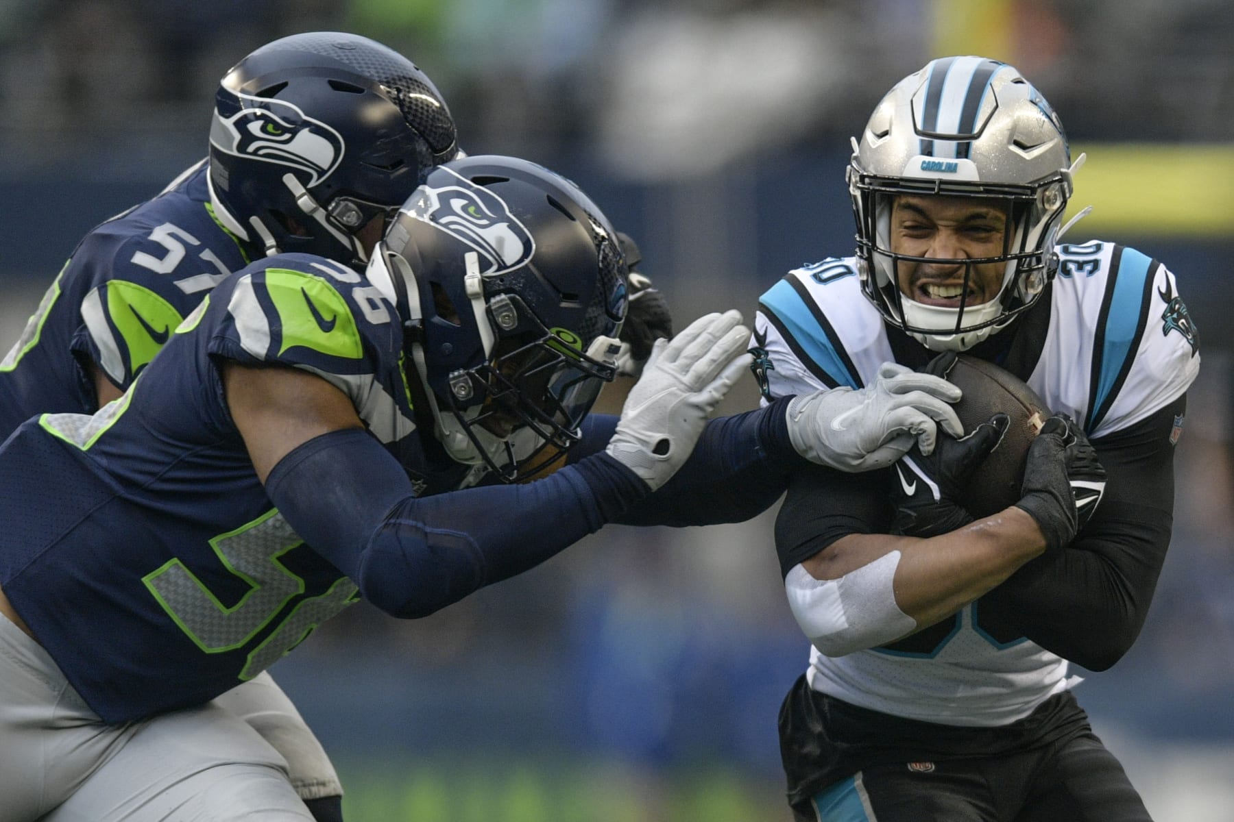 Carolina Panthers running back Chuba Hubbard (30) runs against Seattle Seahawks linebacker Cody Barton (57) during the first half of an NFL football game, Sunday, Dec. 11, 2022, in Seattle. (AP Photo/Caean Couto)