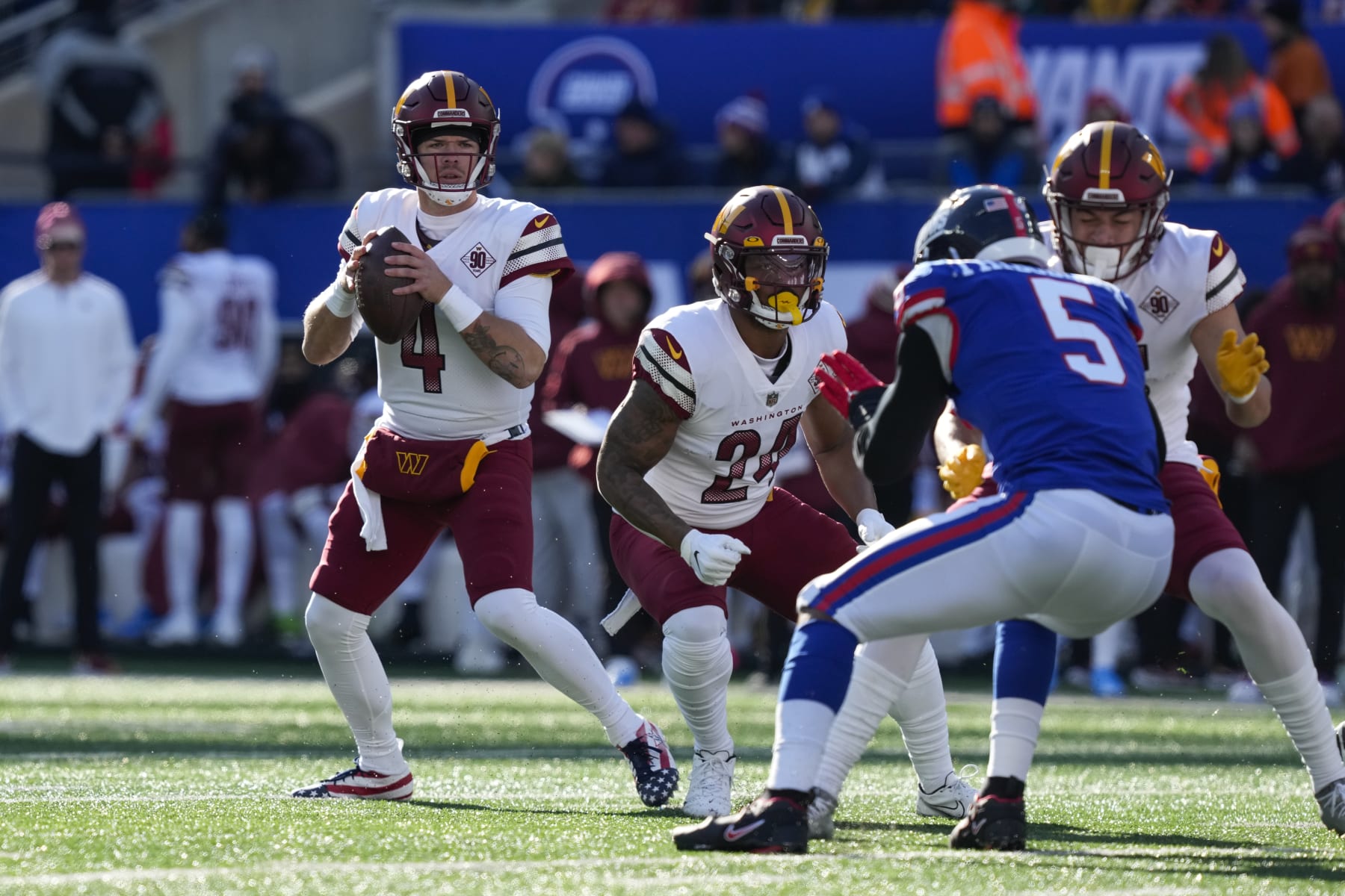 Washington Commanders quarterback Taylor Heinicke (4), left, looks to throw during the first half of an NFL football game against the New York Giants, Sunday, Dec. 4, 2022, in East Rutherford, N.J. (AP Photo/John Minchillo)