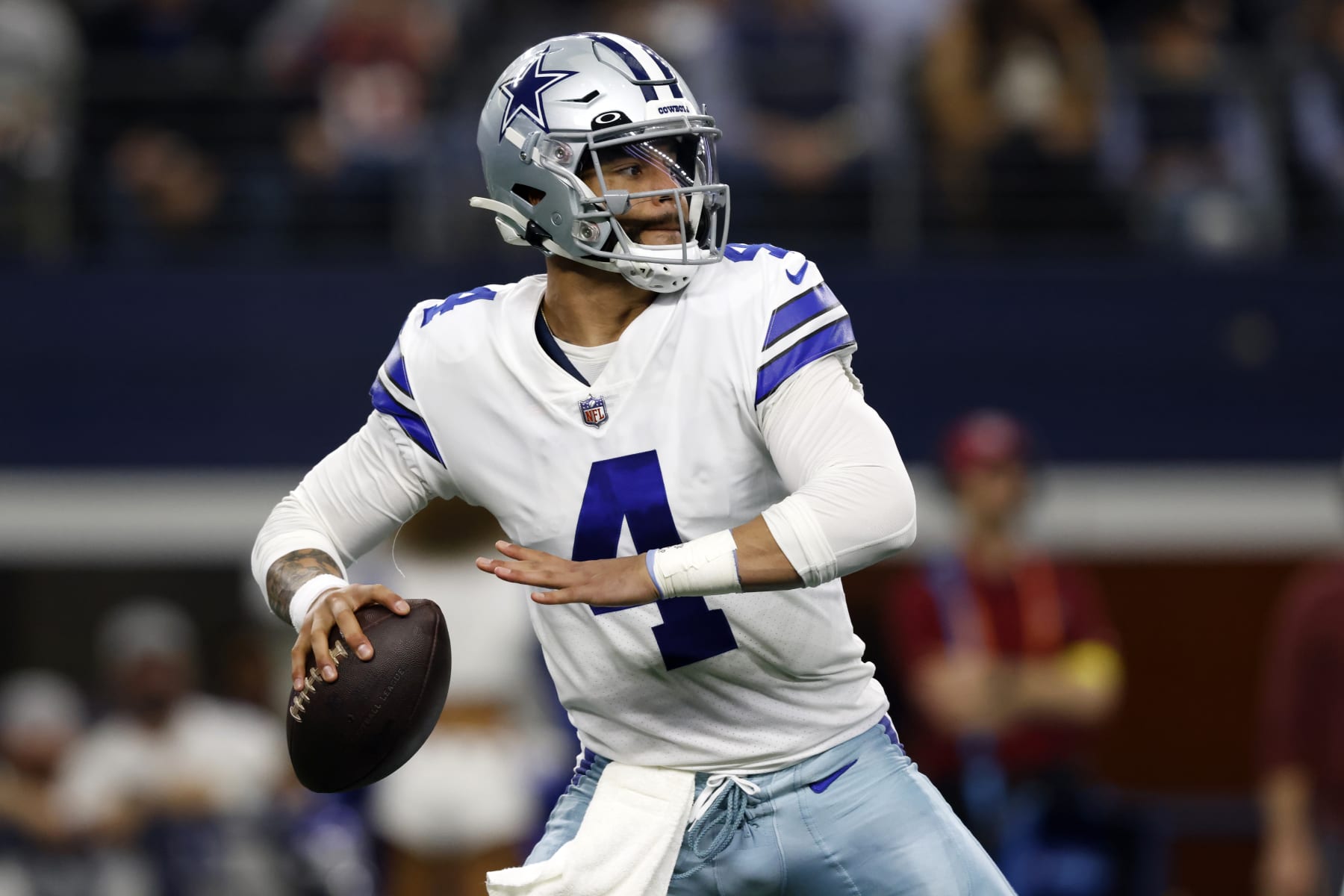 Dallas Cowboys quarterback Dak Prescott (4) looks to throw during the first half of an NFL football game against the Houston Texans, Sunday, Dec. 11, 2022, in Arlington, Texas. (AP Photo/Ron Jenkins)
