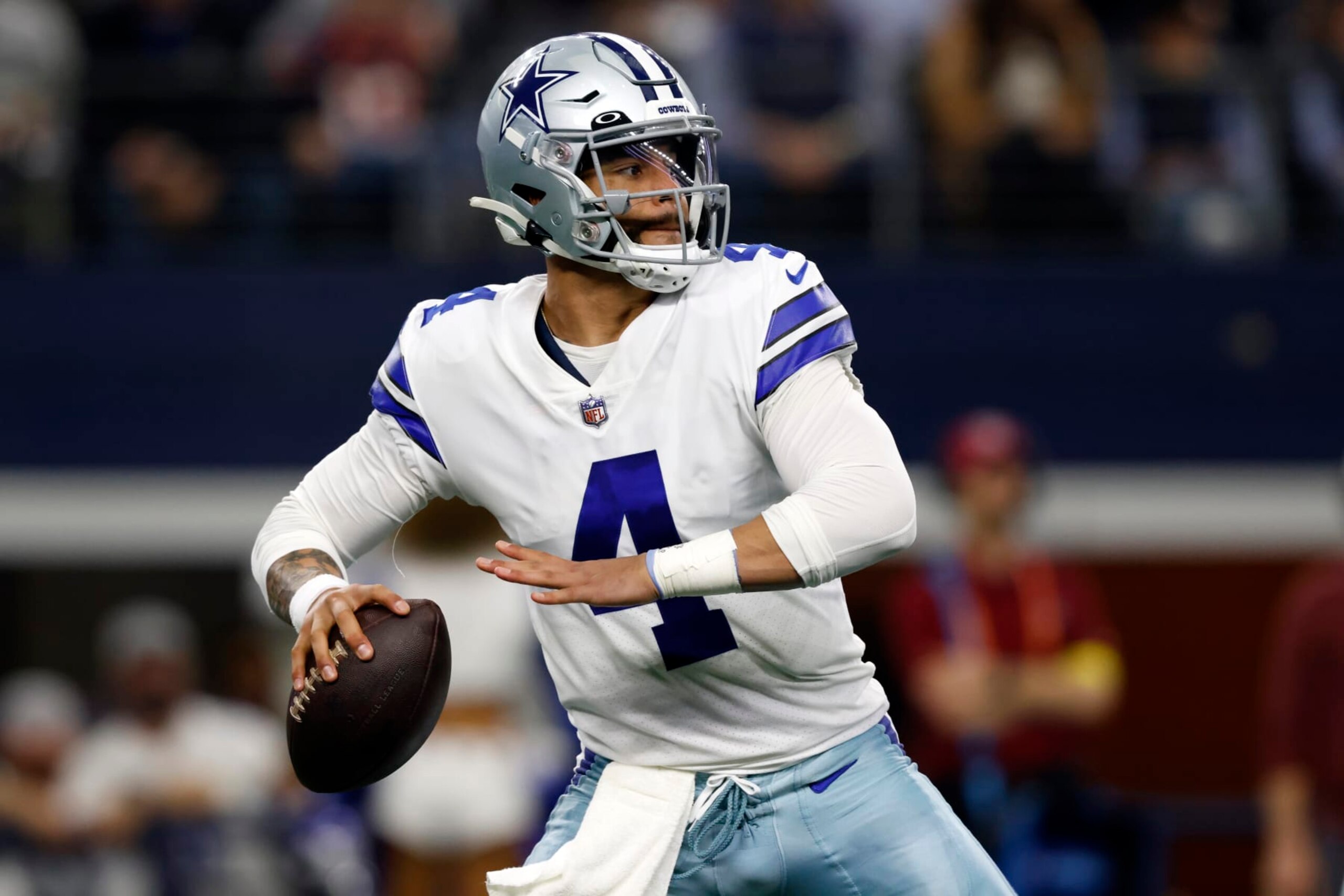 Dallas Cowboys quarterback Dak Prescott (4) looks to throw during the first half of an NFL football game against the Houston Texans, Sunday, Dec. 11, 2022, in Arlington, Texas. (AP Photo/Ron Jenkins)