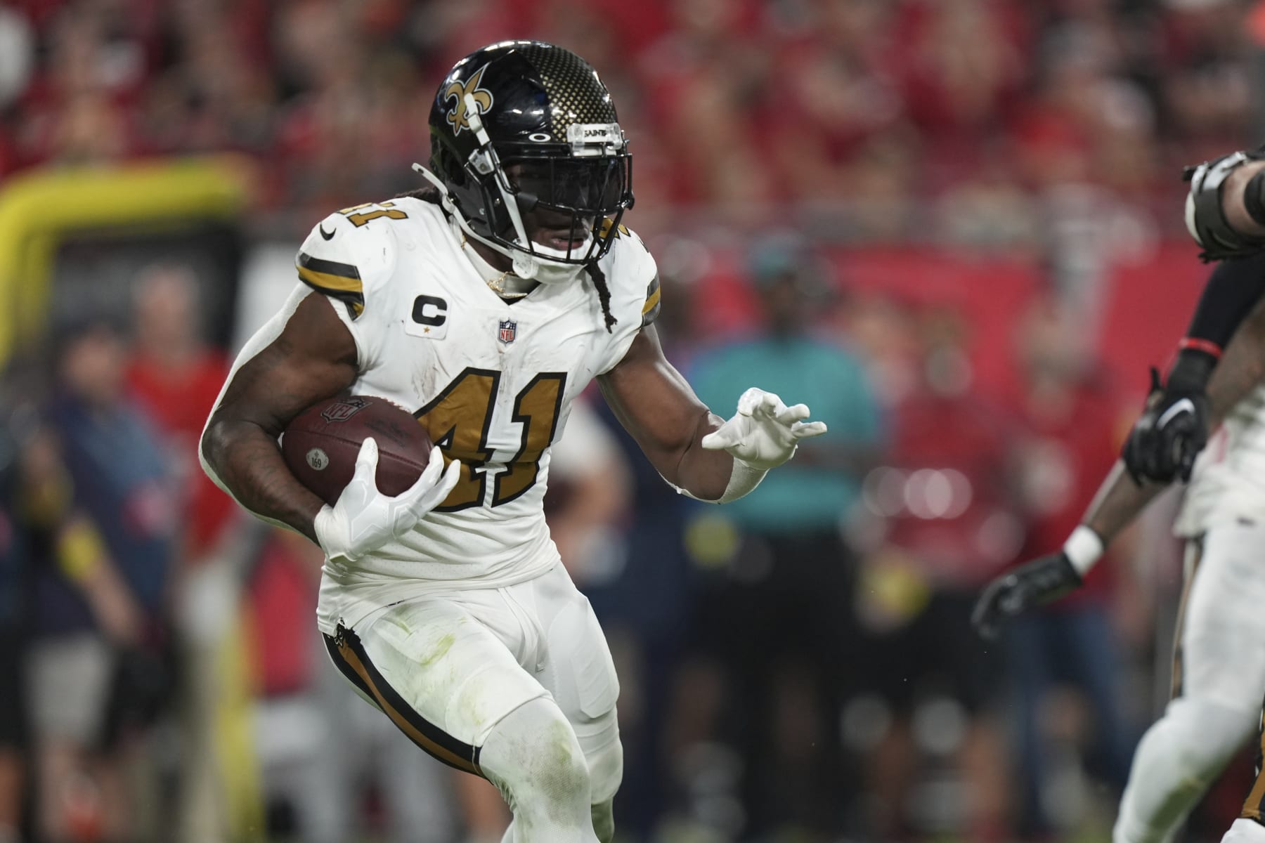 New Orleans Saints running back Alvin Kamara (41) rushes with the ball during an NFL football game against the Tampa Bay Buccaneers, Monday, Dec. 5, 2022, in Tampa, Fla. (AP Photo/Peter Joneleit)