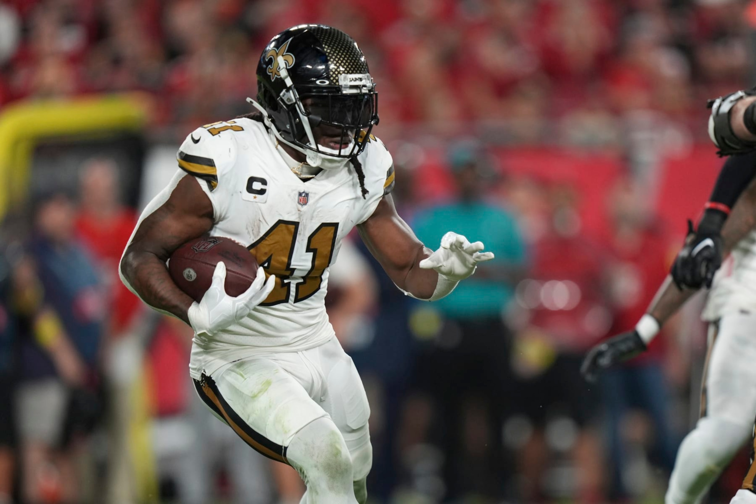 New Orleans Saints running back Alvin Kamara (41) rushes with the ball during an NFL football game against the Tampa Bay Buccaneers, Monday, Dec. 5, 2022, in Tampa, Fla. (AP Photo/Peter Joneleit)