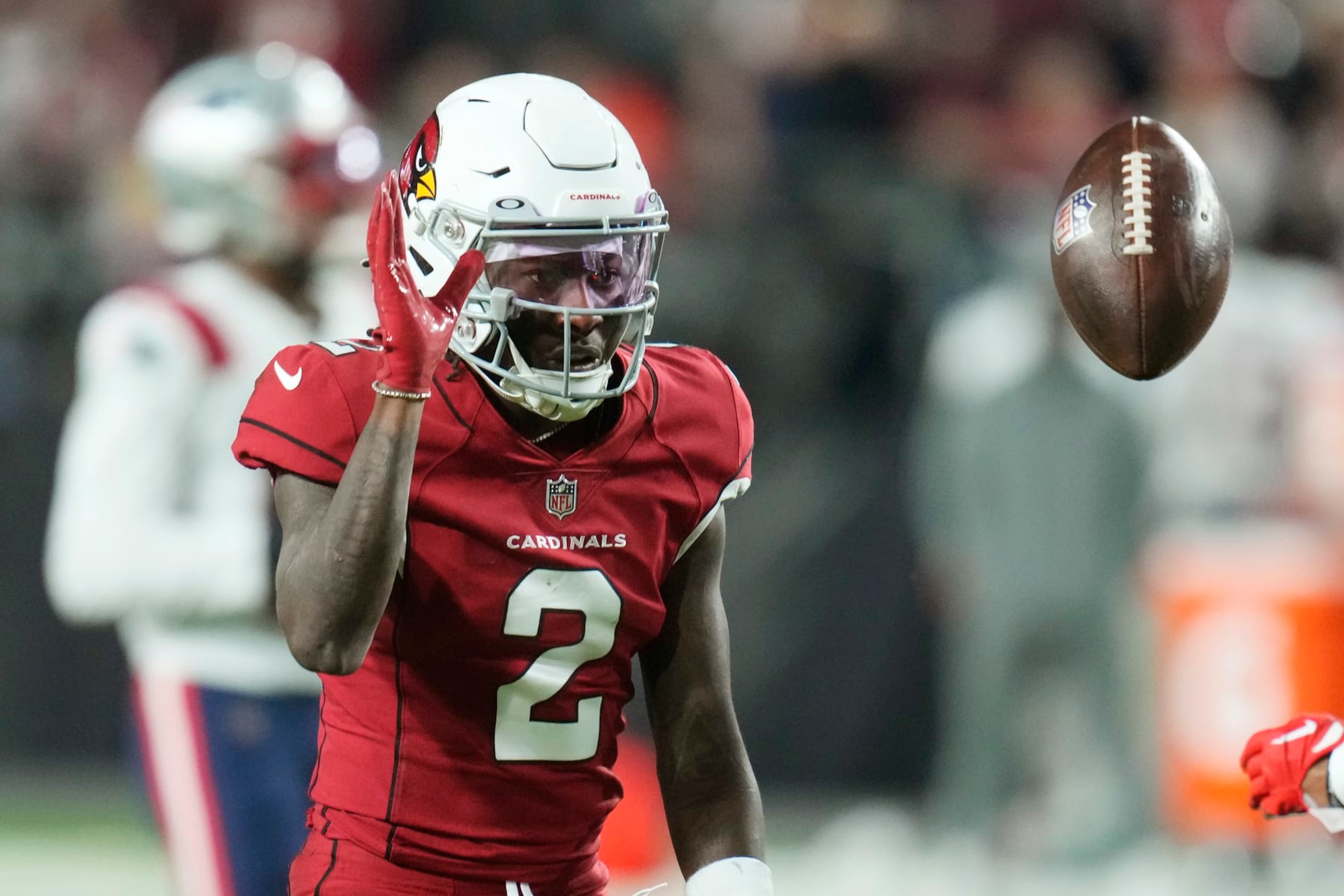 Arizona Cardinals wide receiver Marquise Brown flips the ball back to an official during the first half of an NFL football game against the New England Patriots in Glendale, Ariz., Monday, Dec. 12, 2022. (AP Photo/Ross D. Franklin)