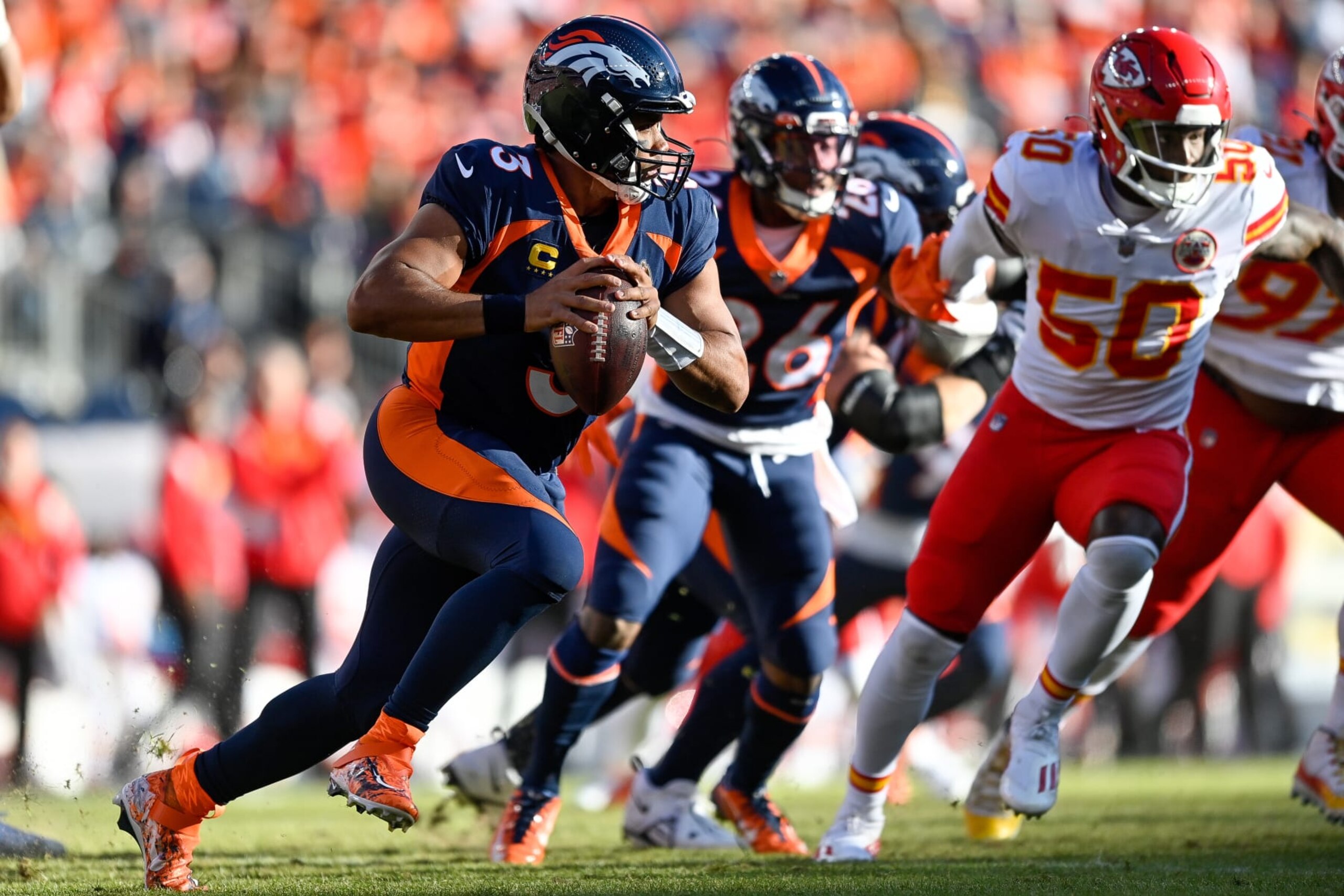 DENVER, CO - DECEMBER 11: Denver Broncos quarterback Russell Wilson (3) scrampes out of the pocket in the first quarter during a game between the Kansas City Chiefs and the Denver Broncos at Empower Field at Mile High on December 11, 2022 in Denver, Colorado. (Photo by Dustin Bradford/Icon Sportswire via Getty Images)