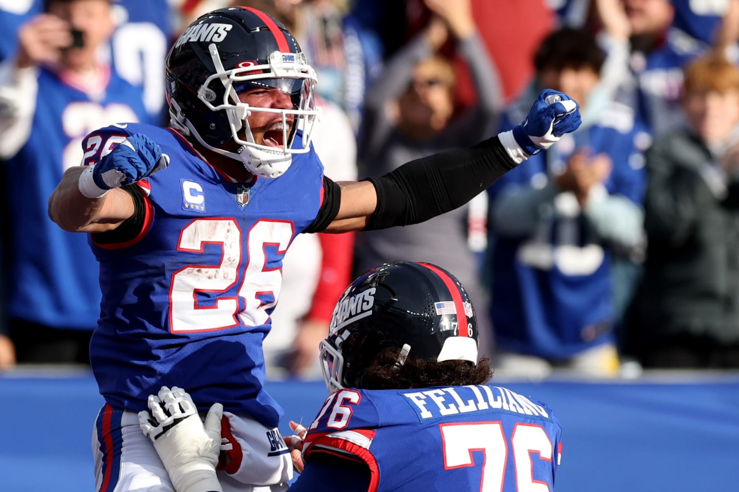 EAST RUTHERFORD, NEW JERSEY - DECEMBER 04: Saquon Barkley #26 of the New York Giants celebrates after a touchdown  in the second quarter of a game against the Washington Commanders at MetLife Stadium on December 04, 2022 in East Rutherford, New Jersey. (Photo by Jamie Squire/Getty Images)