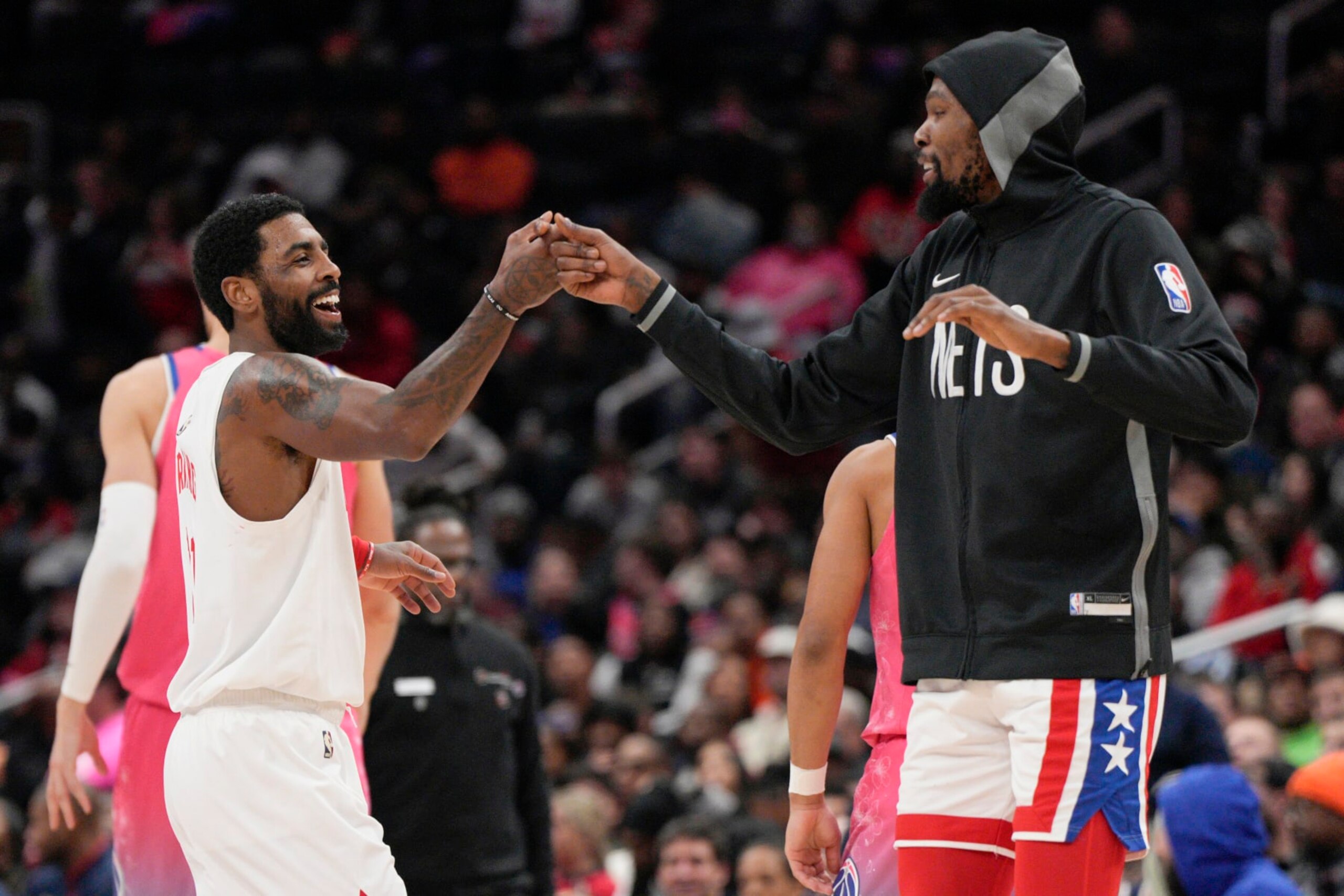 WASHINGTON, DC - DECEMBER 12: Kyrie Irving #11 of the Brooklyn Nets celebrates with Kevin Durant #7 after scoring against the Washington Wizards during the first half at Capital One Arena on December 12, 2022 in Washington, DC. NOTE TO USER: User expressly acknowledges and agrees that, by downloading and or using this photograph, User is consenting to the terms and conditions of the Getty Images License Agreement. (Photo by Jess Rapfogel/Getty Images)