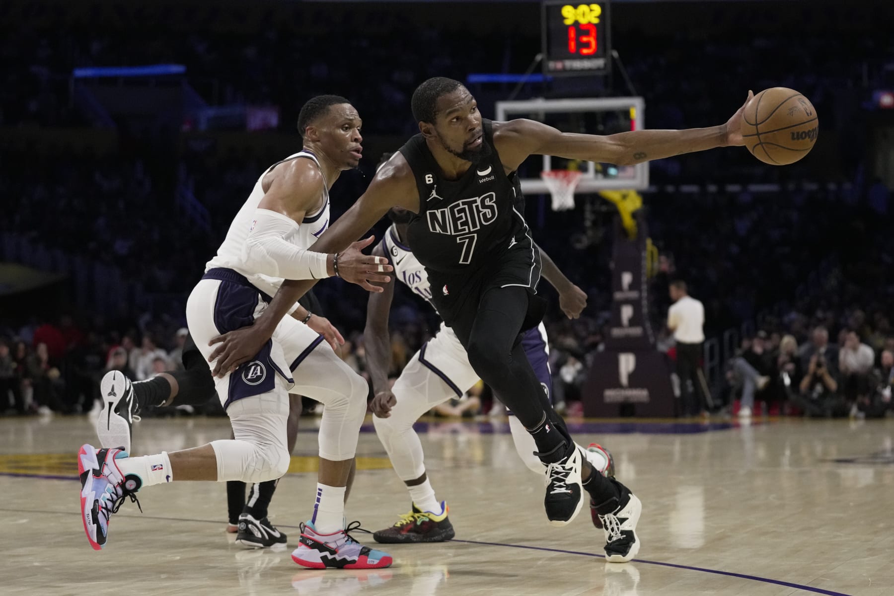 Brooklyn Nets forward Kevin Durant (7) loses the ball while defended by Los Angeles Lakers guard Russell Westbrook (0) during the first half of an NBA basketball game in Los Angeles, Sunday, Nov. 13, 2022. (AP Photo/Ashley Landis)