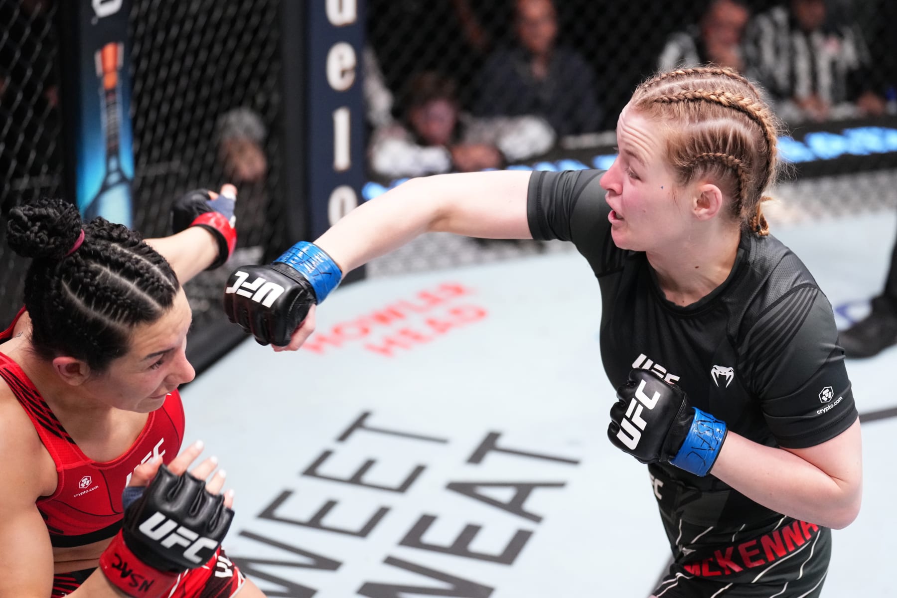 LAS VEGAS, NEVADA - DECEMBER 17: (R-L) Cory McKenna of Wales punches Cheyanne Vlismas in a strawweight fight during the UFC Fight Night event at UFC APEX on December 17, 2022 in Las Vegas, Nevada. (Photo by Chris Unger/Zuffa LLC)