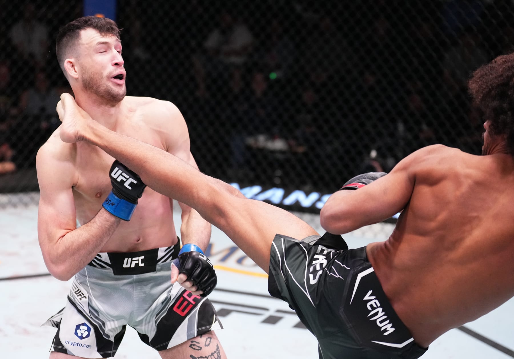 LAS VEGAS, NEVADA - DECEMBER 17: (R-L) Alex Caceres kicks Julian Erosa in a featherweight fight during the UFC Fight Night event at UFC APEX on December 17, 2022 in Las Vegas, Nevada.  (Photo by Chris Unger/Zuffa LLC)