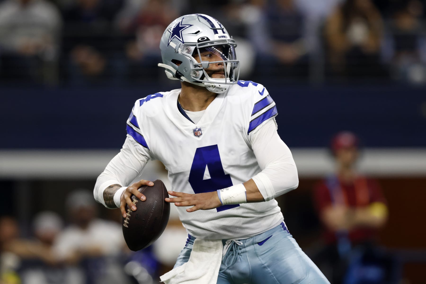 Dallas Cowboys quarterback Dak Prescott (4) looks to throw during the first half of an NFL football game against the Houston Texans, Sunday, Dec. 11, 2022, in Arlington, Texas. (AP Photo/Ron Jenkins)