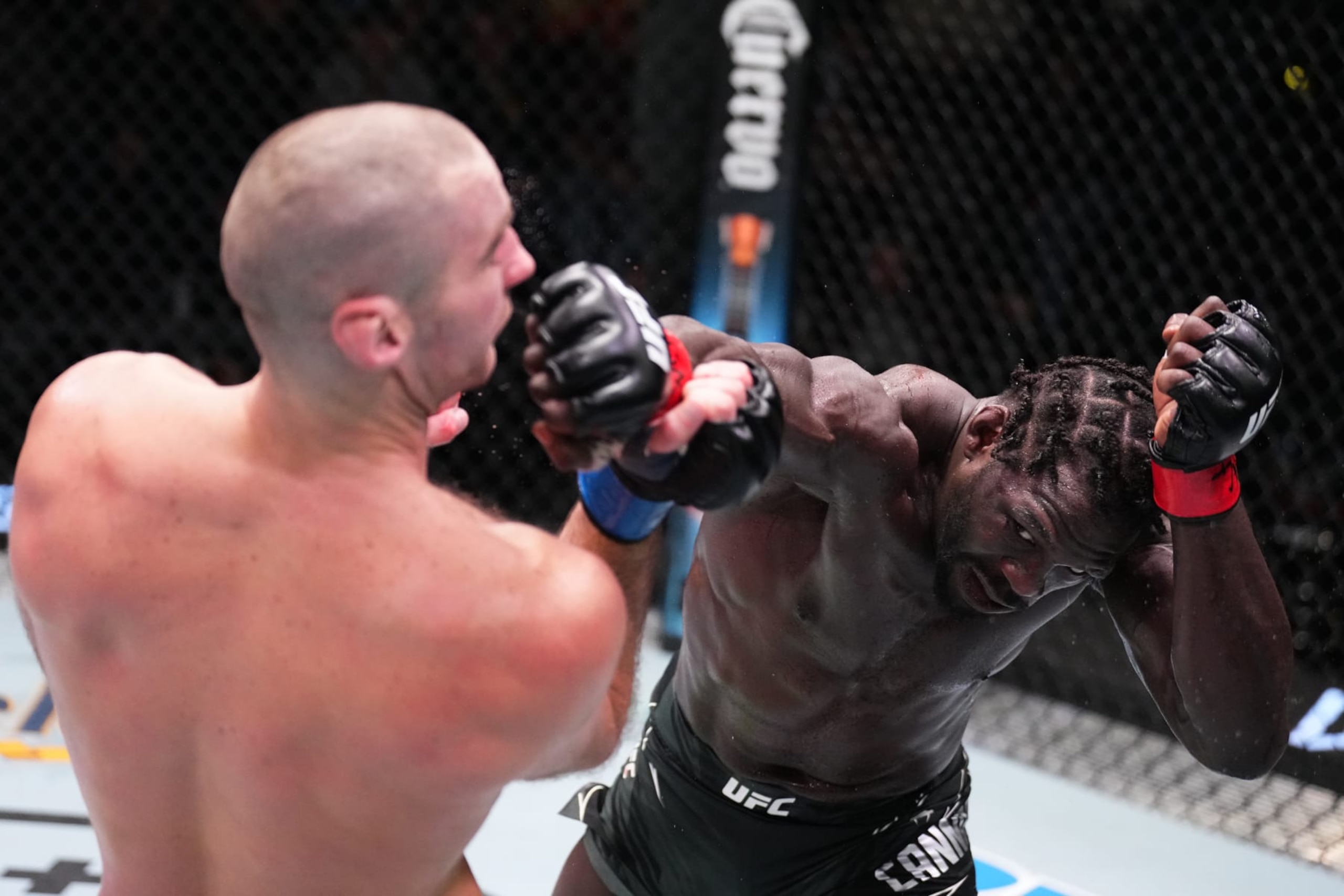 LAS VEGAS, NEVADA - DECEMBER 17: (R-L) Jared Cannonier punches Sean Strickland in a middleweight fight during the UFC Fight Night event at UFC APEX on December 17, 2022 in Las Vegas, Nevada. (Photo by Chris Unger/Zuffa LLC)