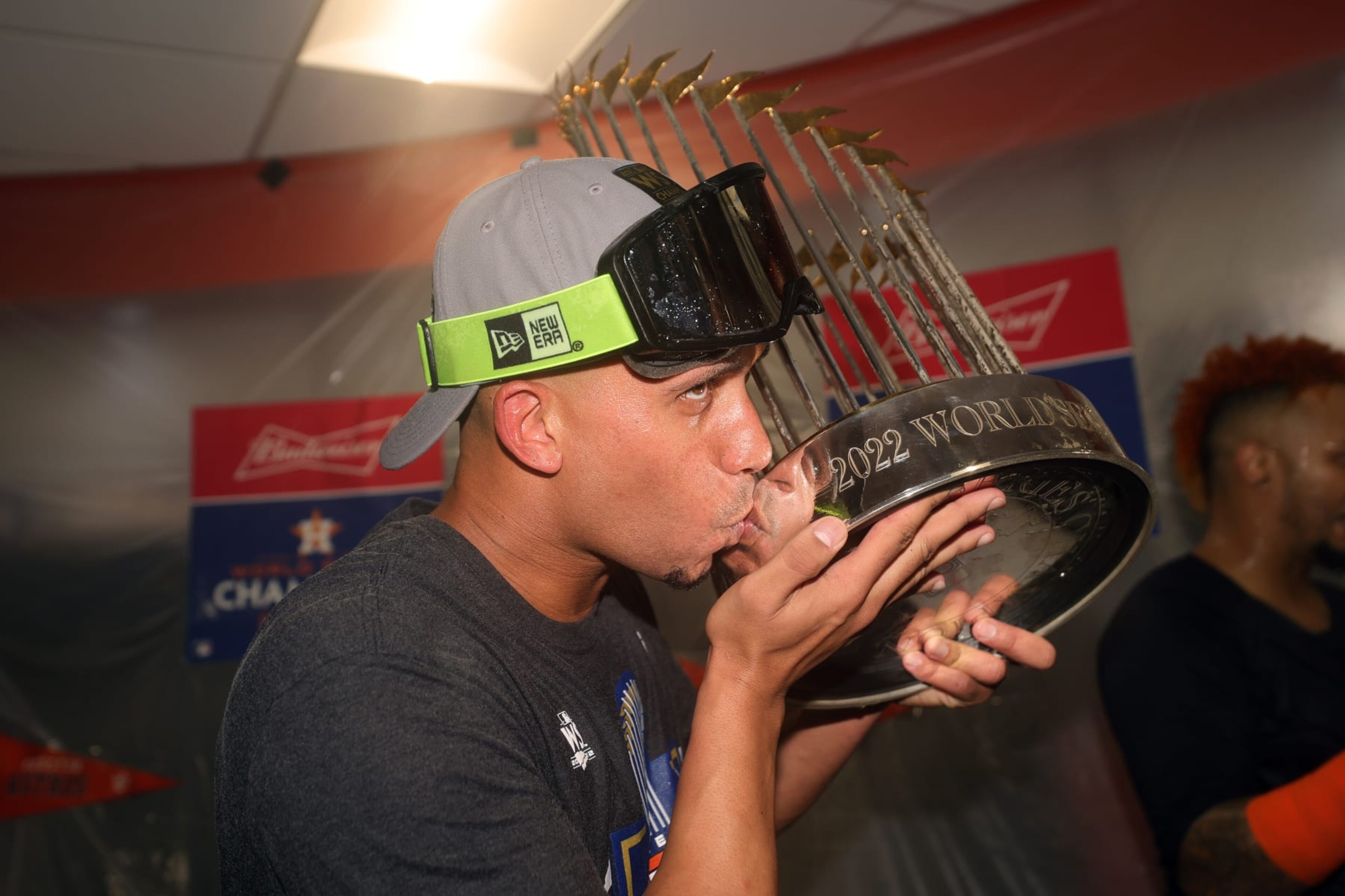 HOUSTON, TEXAS - NOVEMBER 05: Michael Brantley #23 of the Houston Astros celebrates in the clubhouse while holding the commissioner's trophy after defeating the Philadelphia Phillies 4-1 to win the 2022 World Series in Game Six of the 2022 World Series at Minute Maid Park on November 05, 2022 in Houston, Texas. (Photo by Carmen Mandato/Getty Images) HOUSTON, TEXAS - NOVEMBER 05: Michael Brantley #23 of the Houston Astros celebrates in the clubhouse while holding the commissioner's trophy after defeating the Philadelphia Phillies 4-1 to win the 2022 World Series in Game Six of the 2022 World Series at Minute Maid Park on November 05, 2022 in Houston, Texas. (Photo by Carmen Mandato/Getty Images)