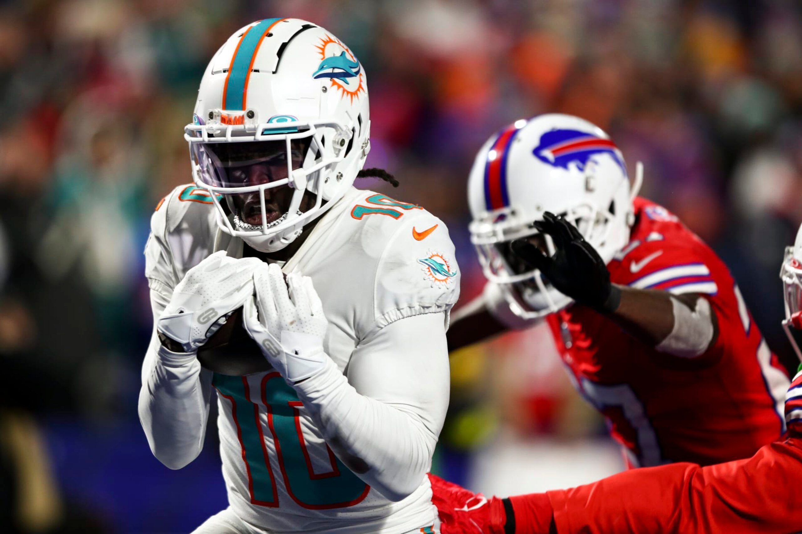 ORCHARD PARK, NY - DECEMBER 17: Tyreek Hill #10 of the Miami Dolphins catches a pass for a touchdown during the third quarter of an NFL football game against the Buffalo Bills at Highmark Stadium on December 17, 2022 in Orchard Park, New York. (Photo by Kevin Sabitus/Getty Images)