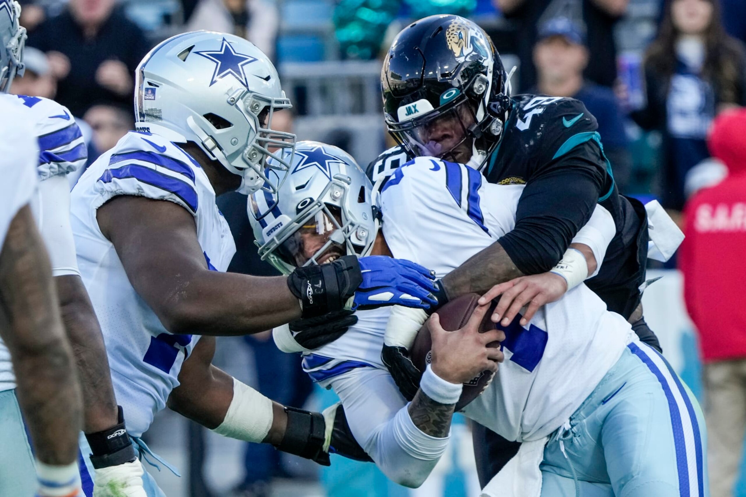 Jacksonville Jaguars defensive end Arden Key (49) sacks Dallas Cowboys quarterback Dak Prescott (4) during the second half of an NFL football game, Sunday, Dec. 18, 2022, in Jacksonville, Fla. (AP Photo/John Raoux)